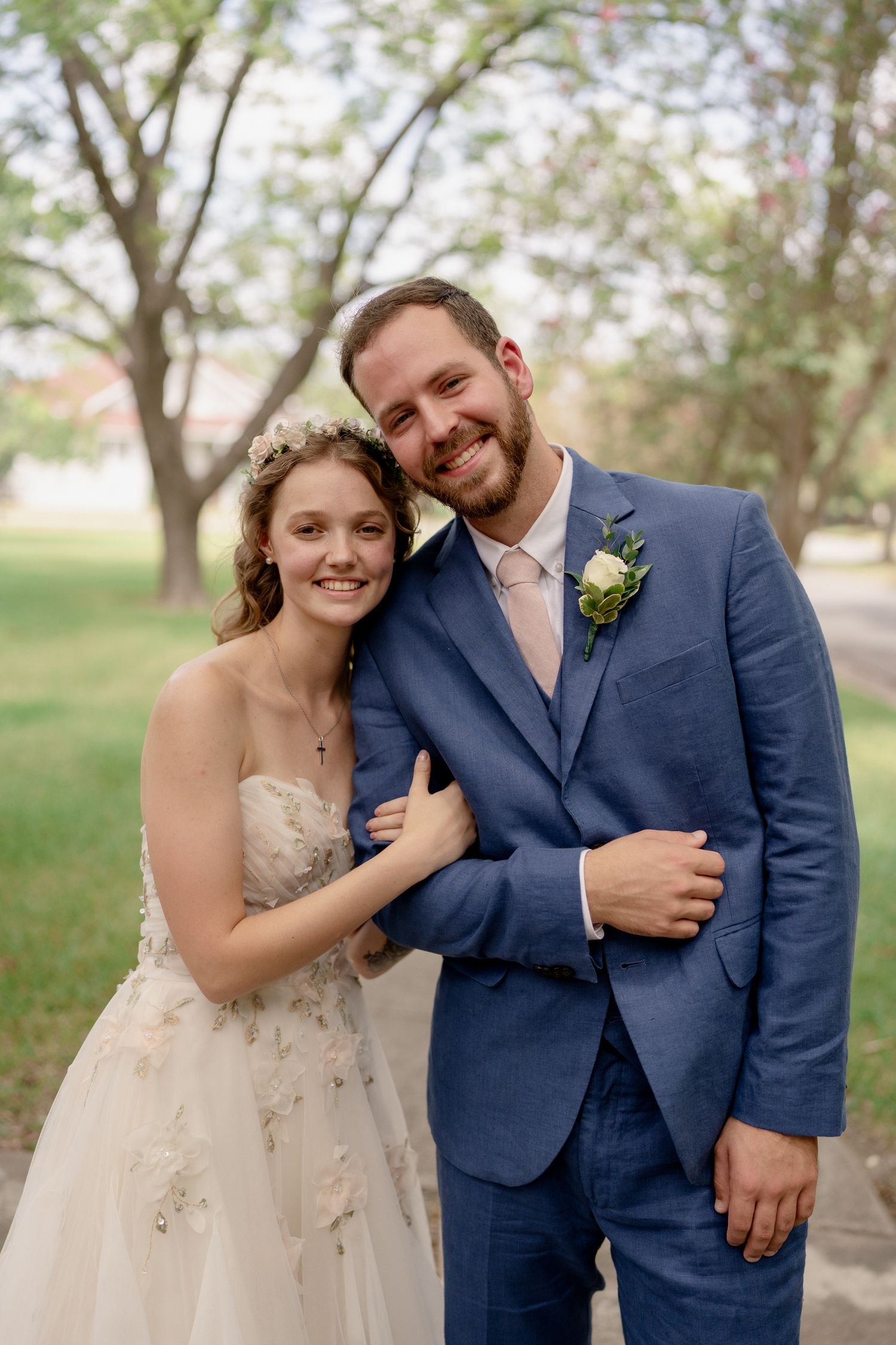 Joyful wedding couple shares candid moments during their outdoor photo session.