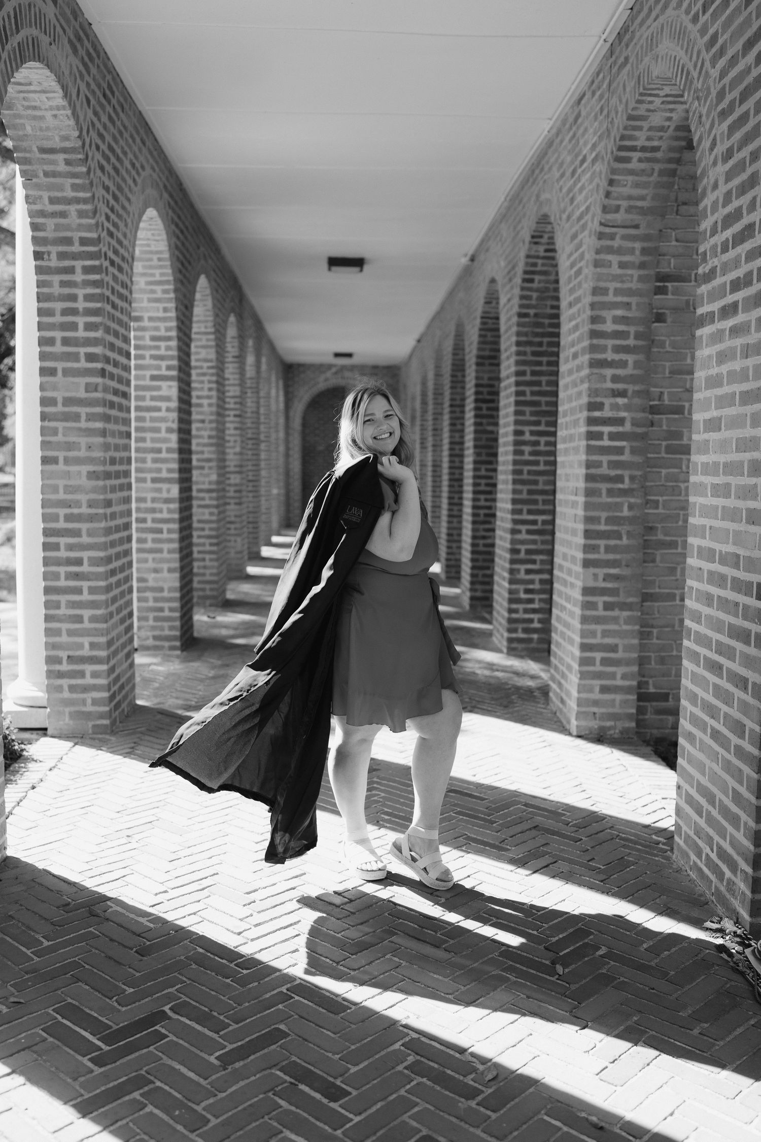 A sequence of black and white photos showing a figure in dark clothing moving through an arched brick corridor.