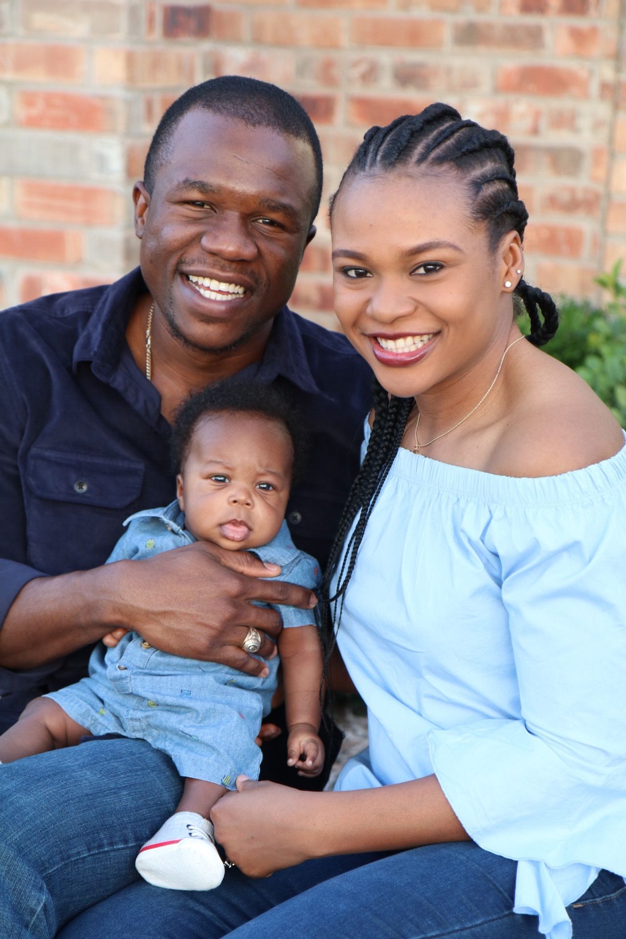 Family of three sharing tender moments together during an outdoor photo session.