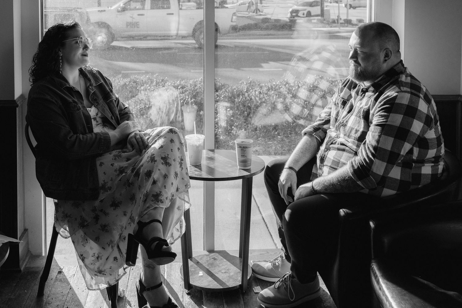 A couple sharing an intimate black and white moment together indoors.