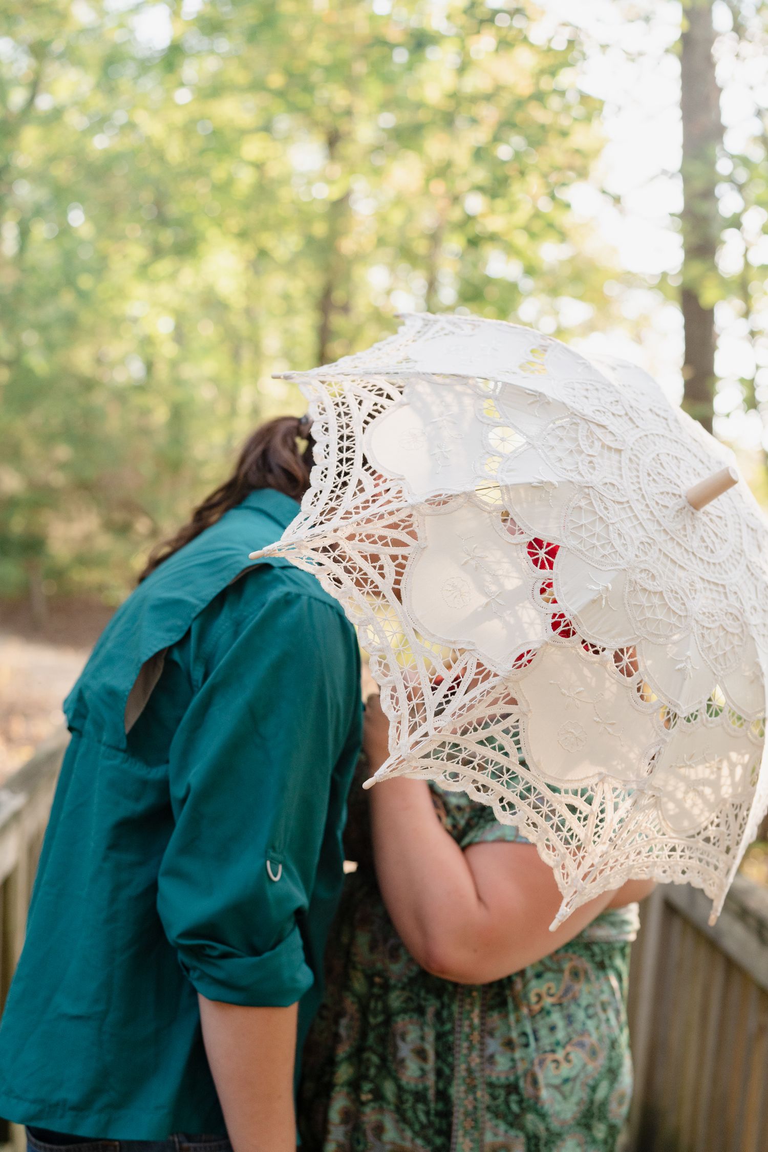 A sequence of photos showing someone holding a delicate white lace parasol in a garden setting.
