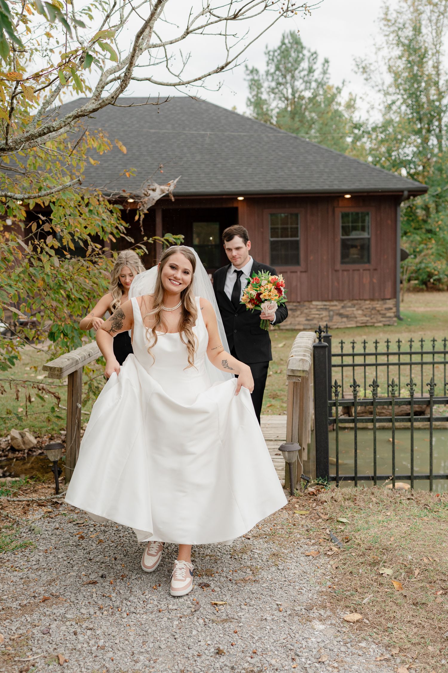 A series of photos showing a bride in a white dress and sneakers walking on a gravel path near a rustic building.