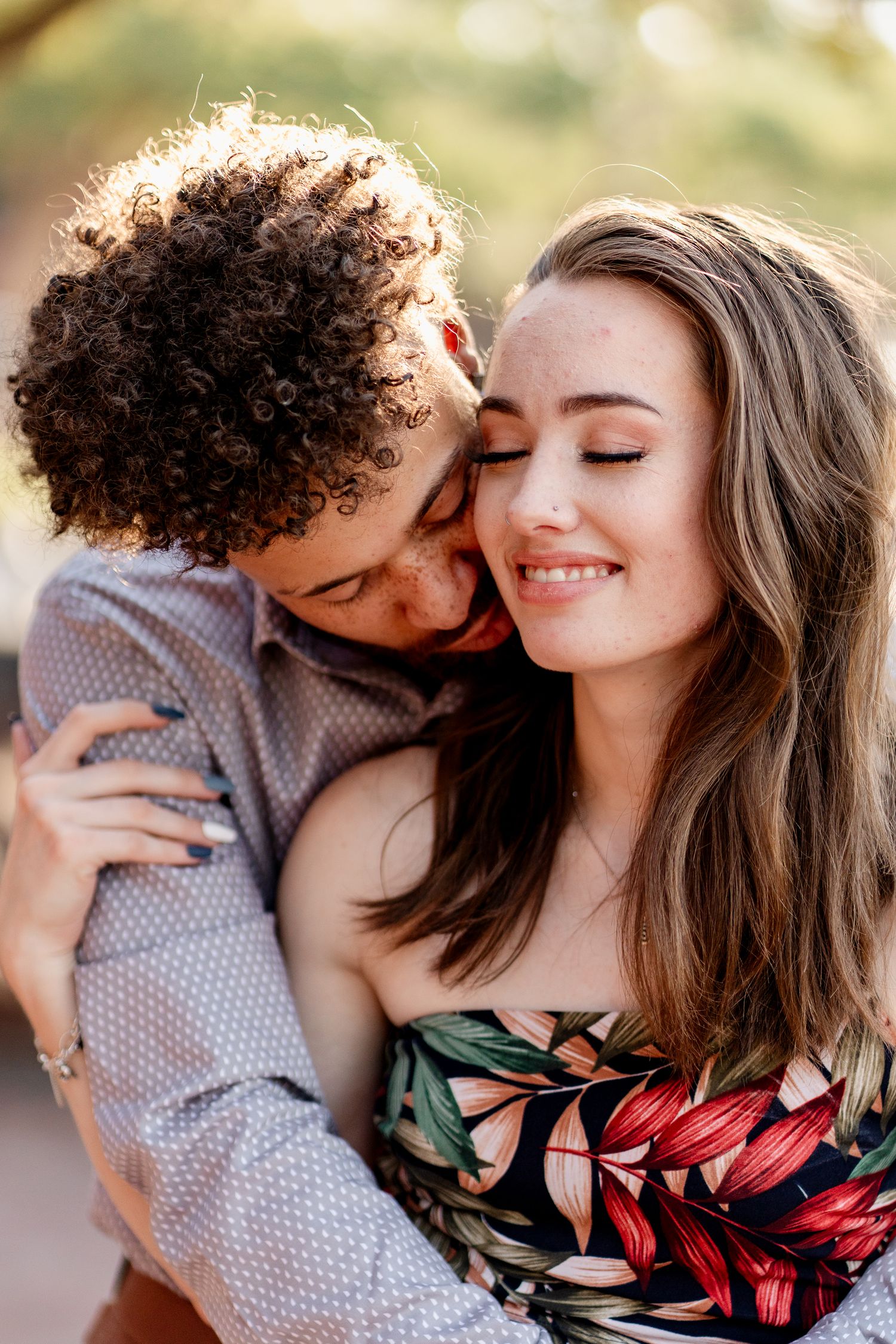 A couple shares tender moments during their outdoor portrait session.