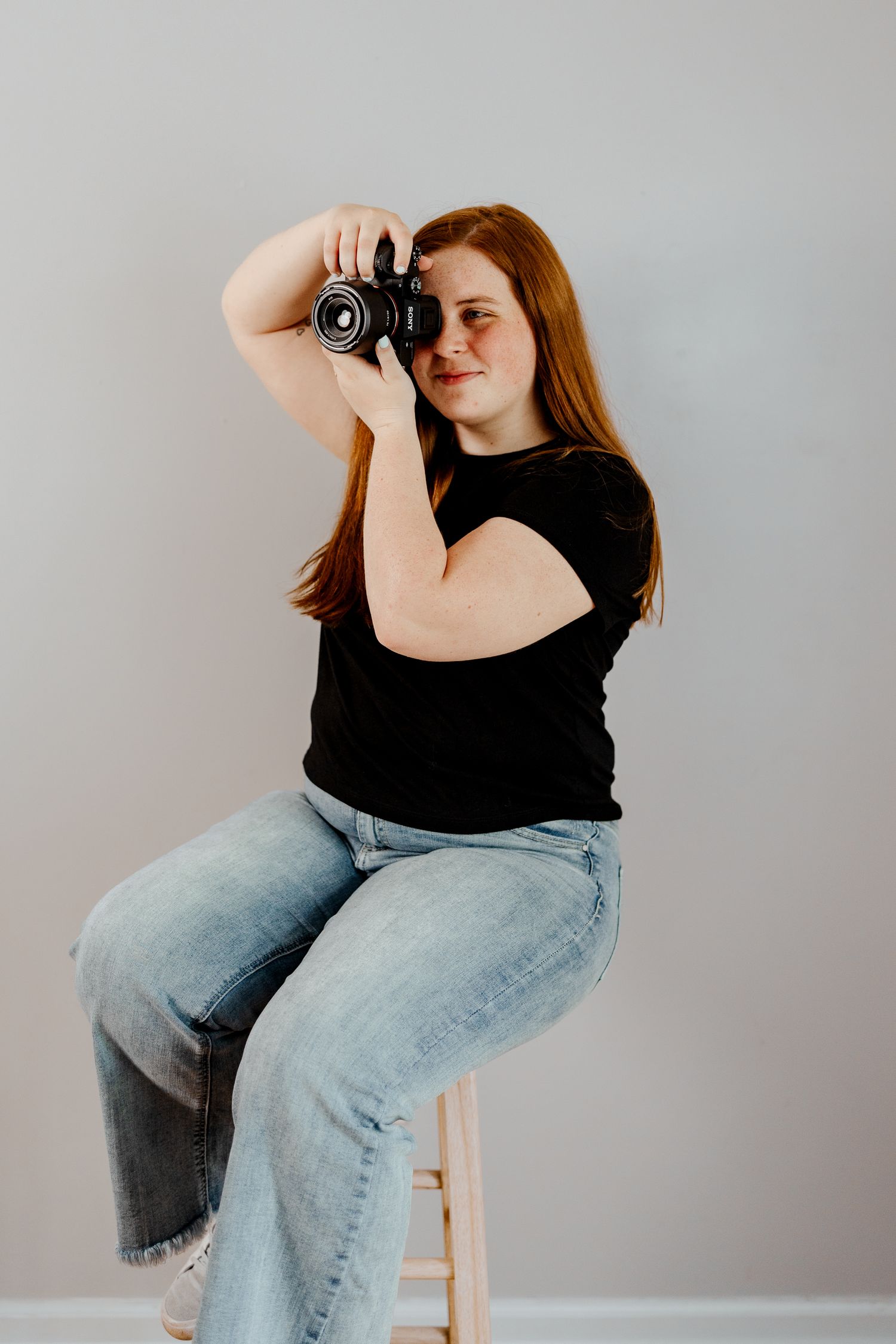Creative self-portrait session showing different camera angles and poses on white furniture.