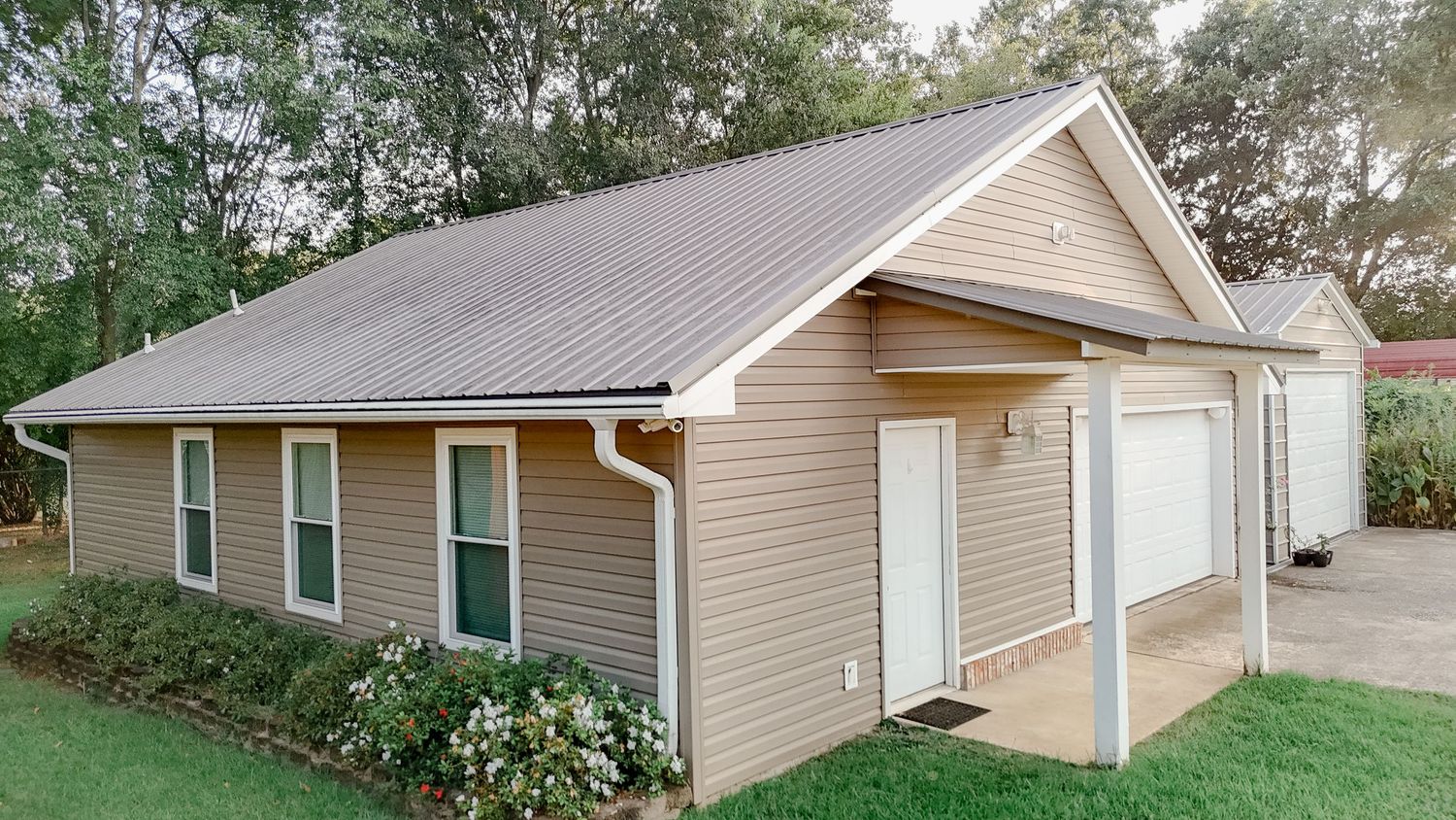 Five connected exterior photos showing a tan vinyl-sided house with white trim and landscaping from different angles.