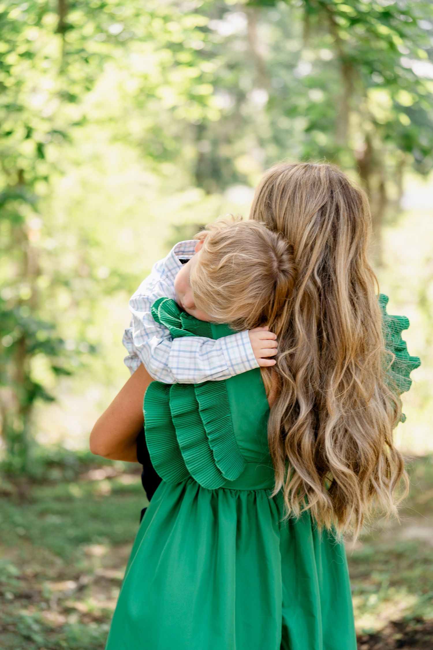 Close-up of ruffled details on green dress during outdoor photoshoot.