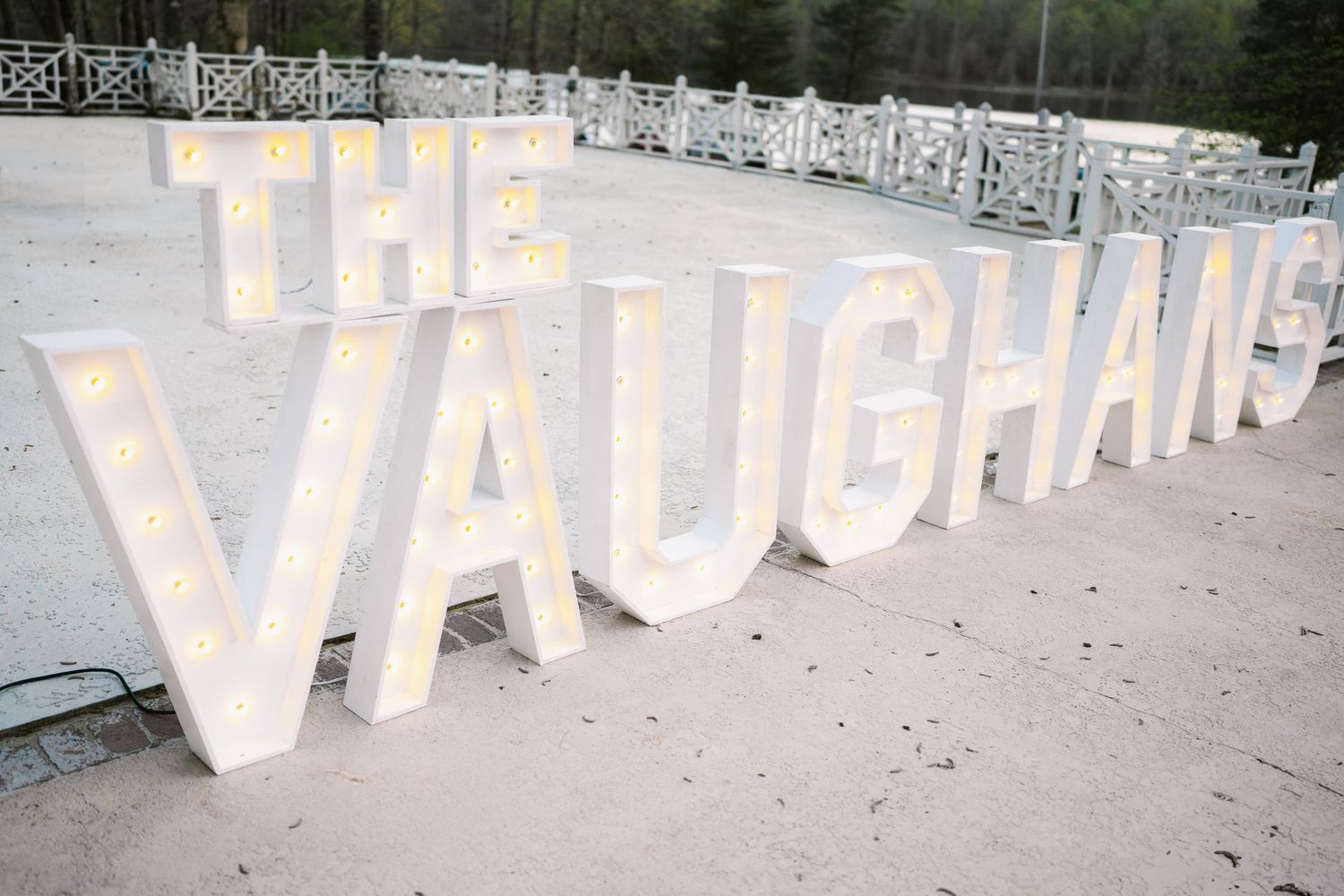Large illuminated marquee letters spelling THE VAUGHANS at an outdoor venue.