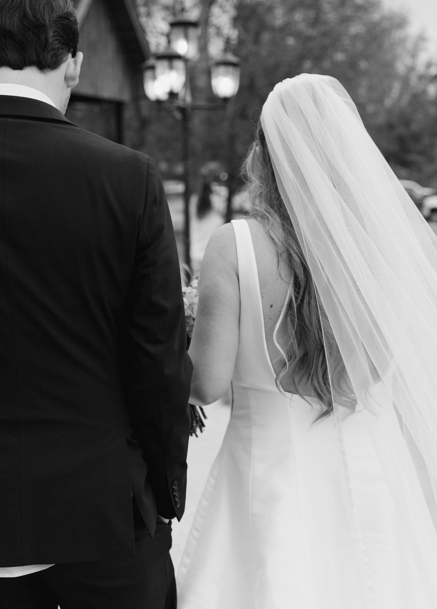 Black and white series showing bride in flowing veil with groom.