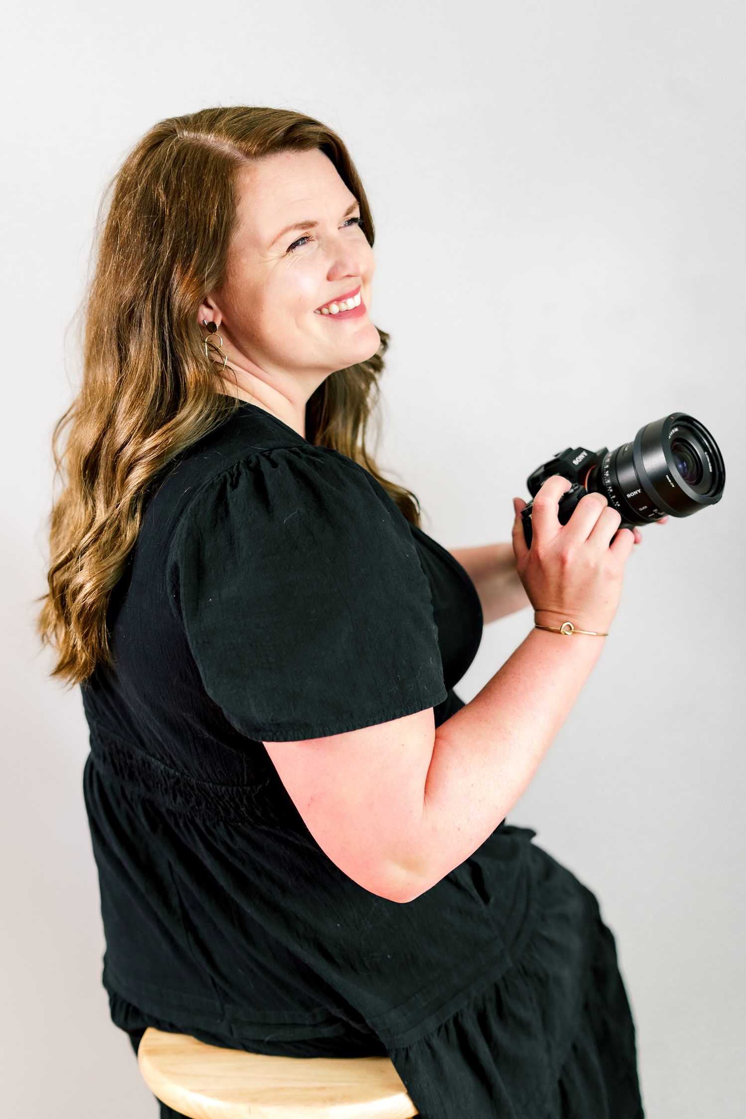 A photographer demonstrates different camera angles and poses in a creative photo series.