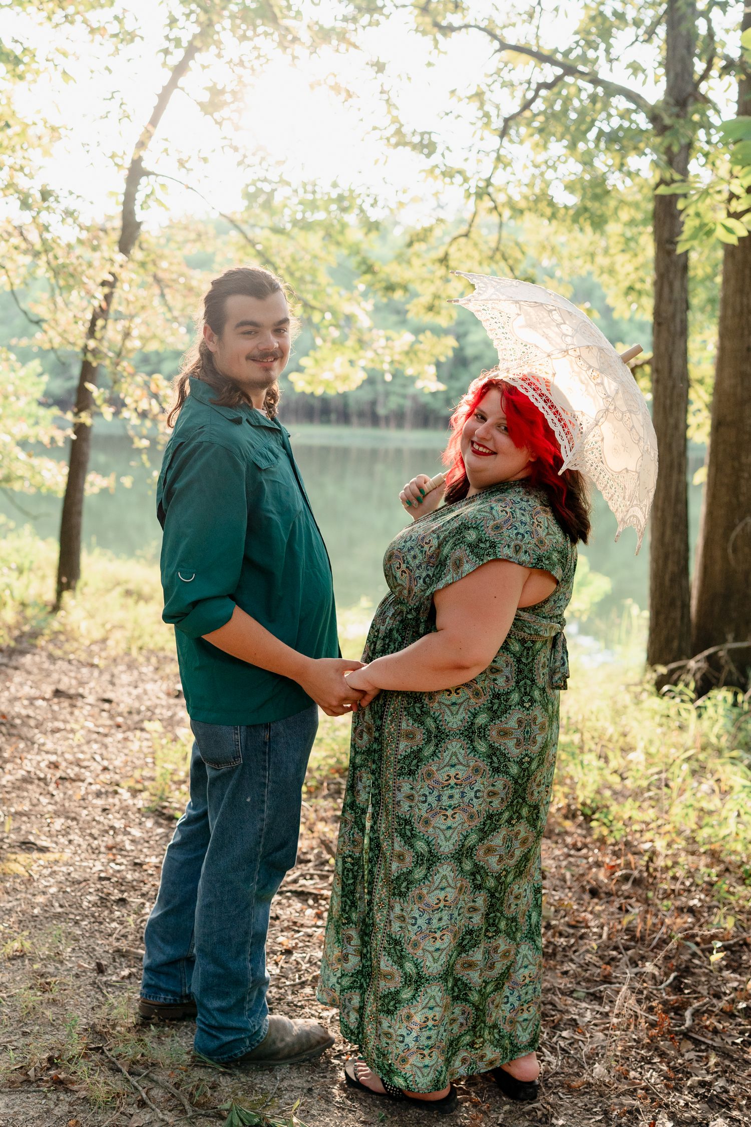 A series of playful outdoor photos showing a couple embracing and laughing together by a lake in autumn.