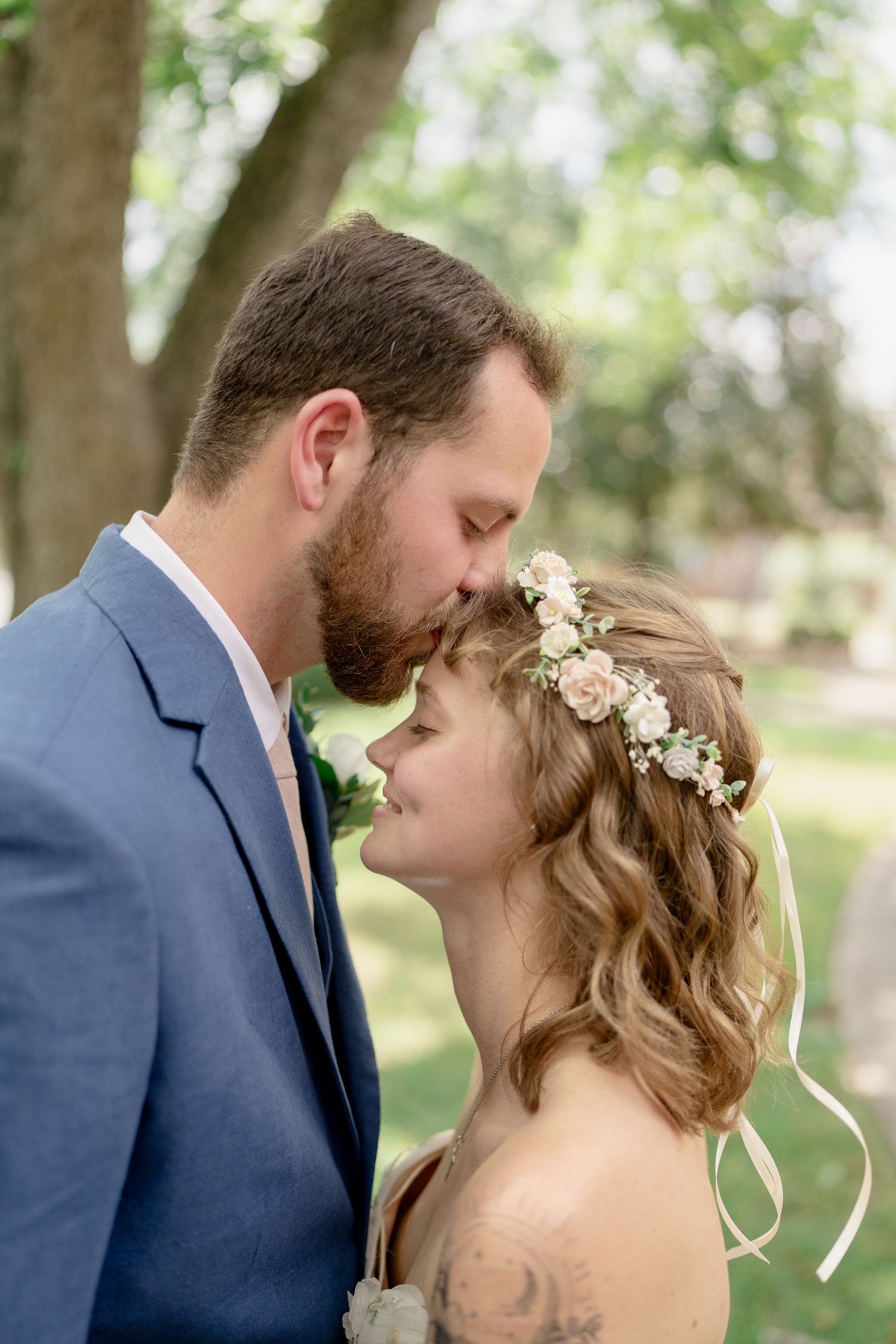 A romantic wedding photoshoot sequence showing tender moments between a couple in a wooded setting.