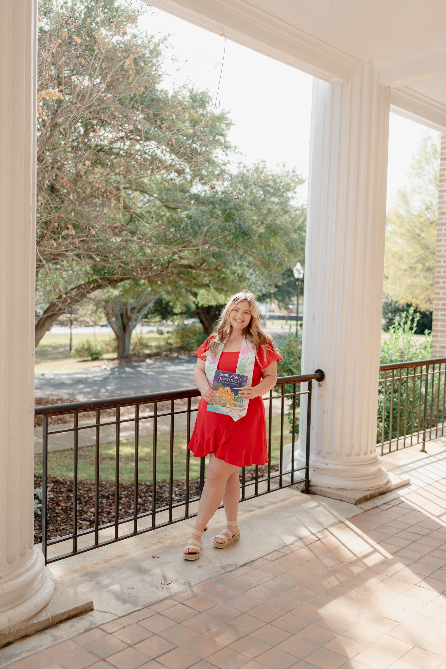 A series of four photos showing someone in a red dress posing on a white columned porch with black railings.