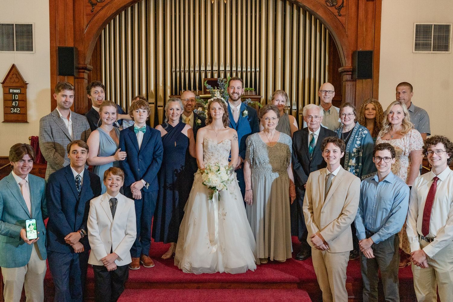 A panoramic collage of wedding ceremony moments showing guests and decorative church interior elements.