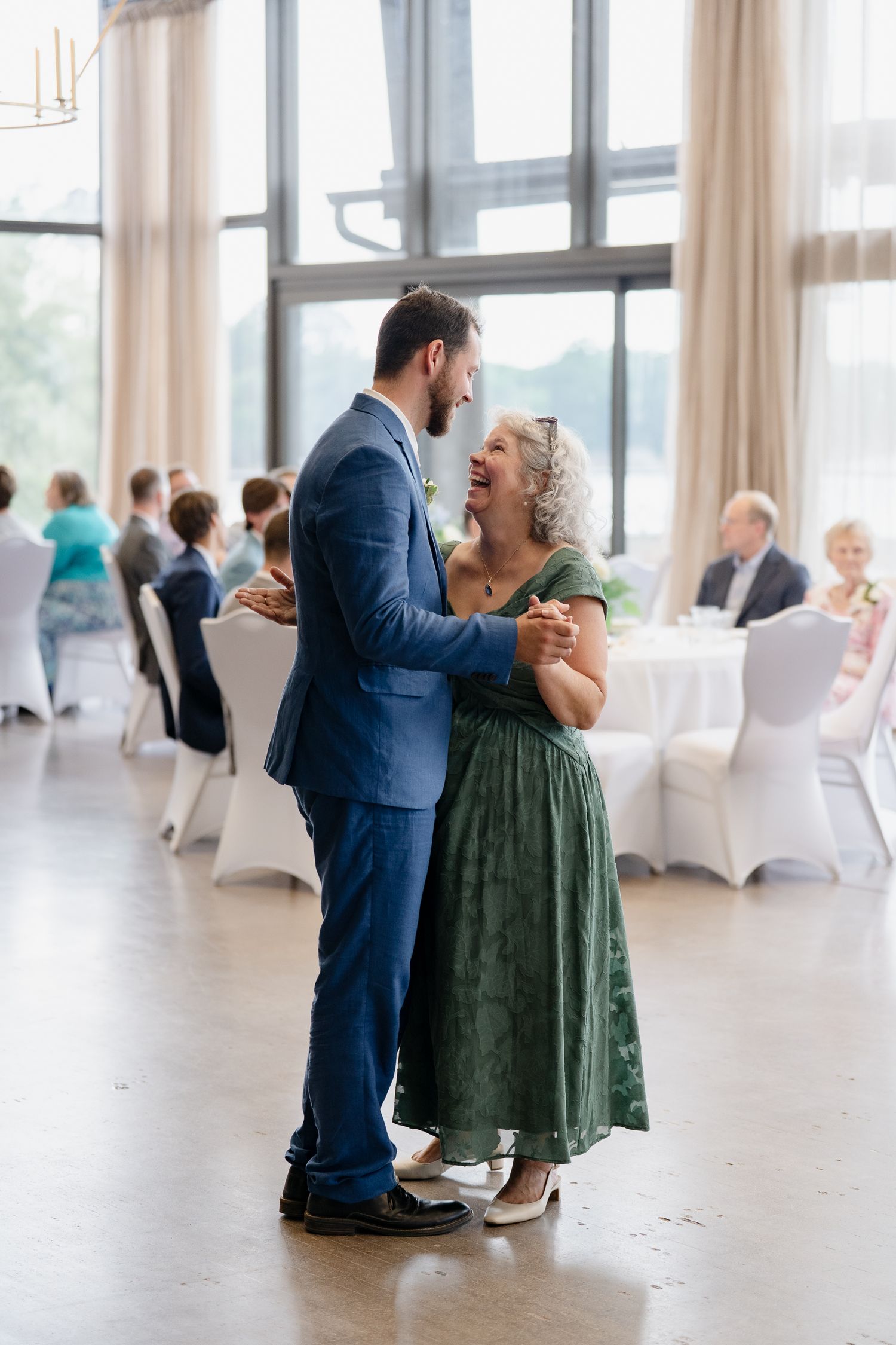 A series of candid dance photos showing a couple sharing intimate moments on their wedding day in a bright reception hall.