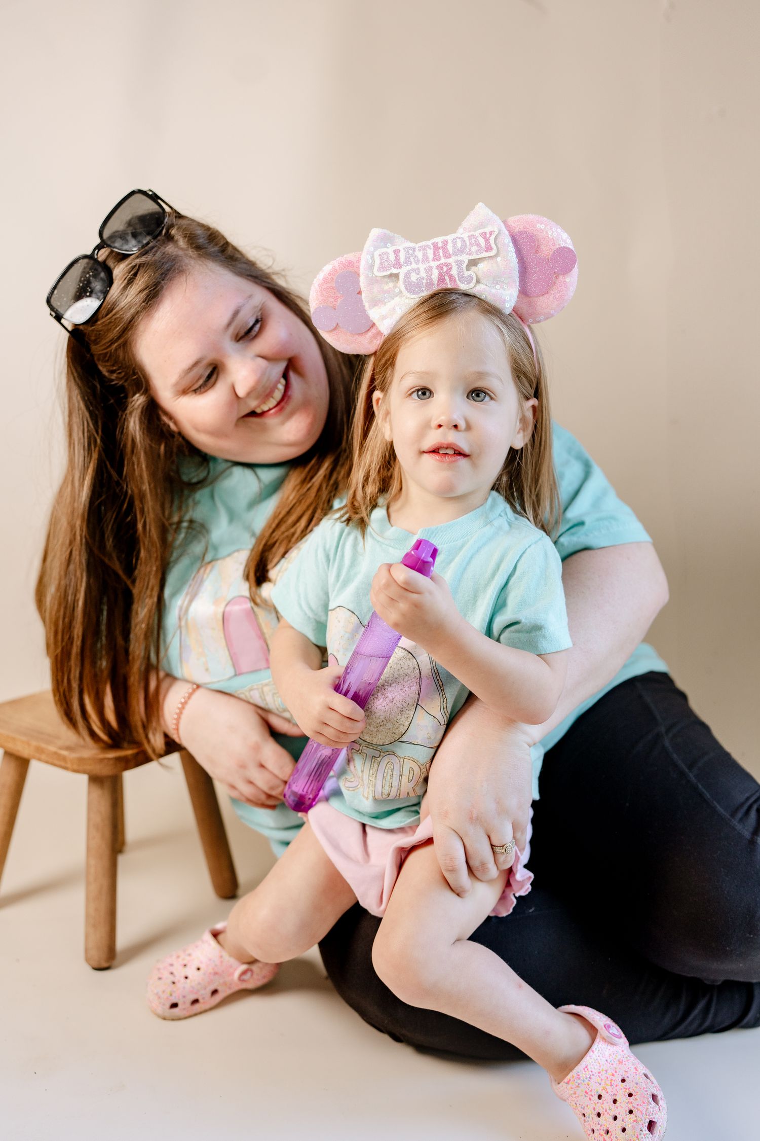 Parent and child share tender moments with pink toys and accessories.
