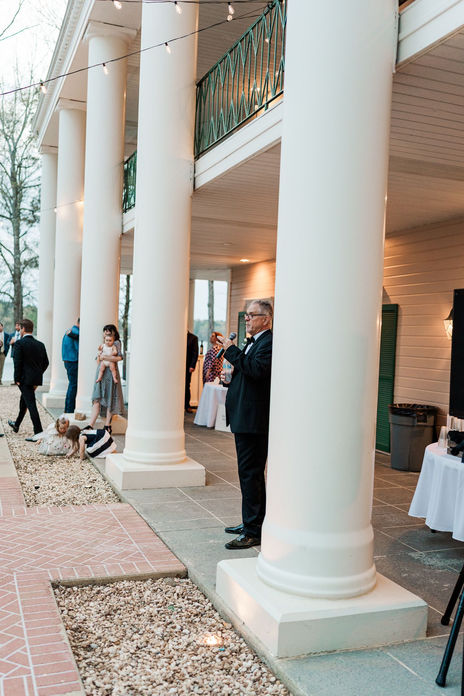 Classic white columned venue entrance during an evening event.