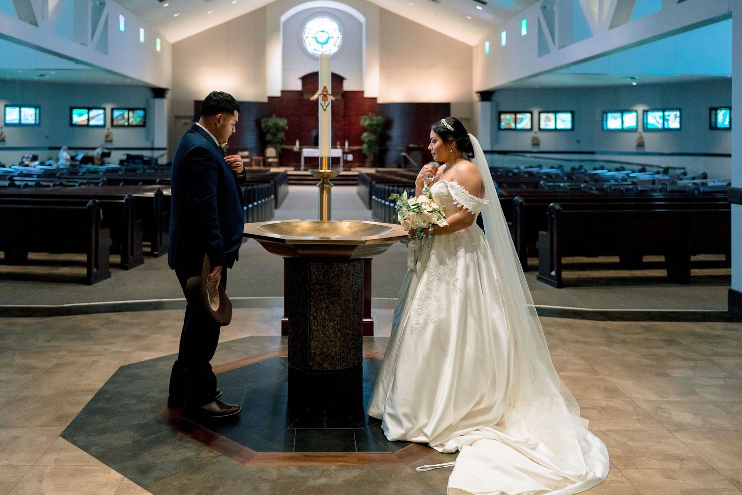 Couple dancing in an elegant ballroom setting with white dress flowing gracefully across the polished floor.