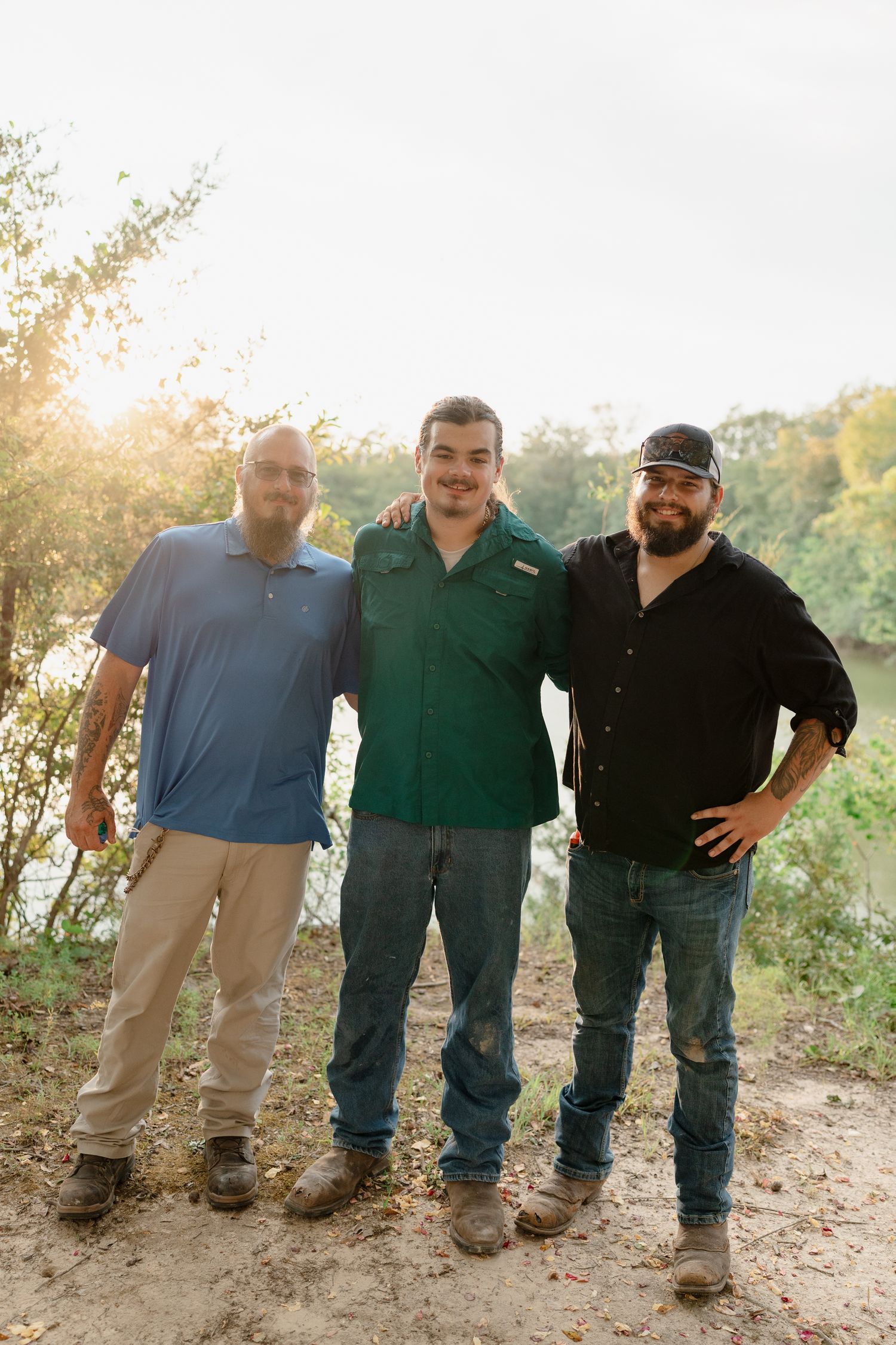 A series of casual group photos showing people standing together on a dirt path near water.