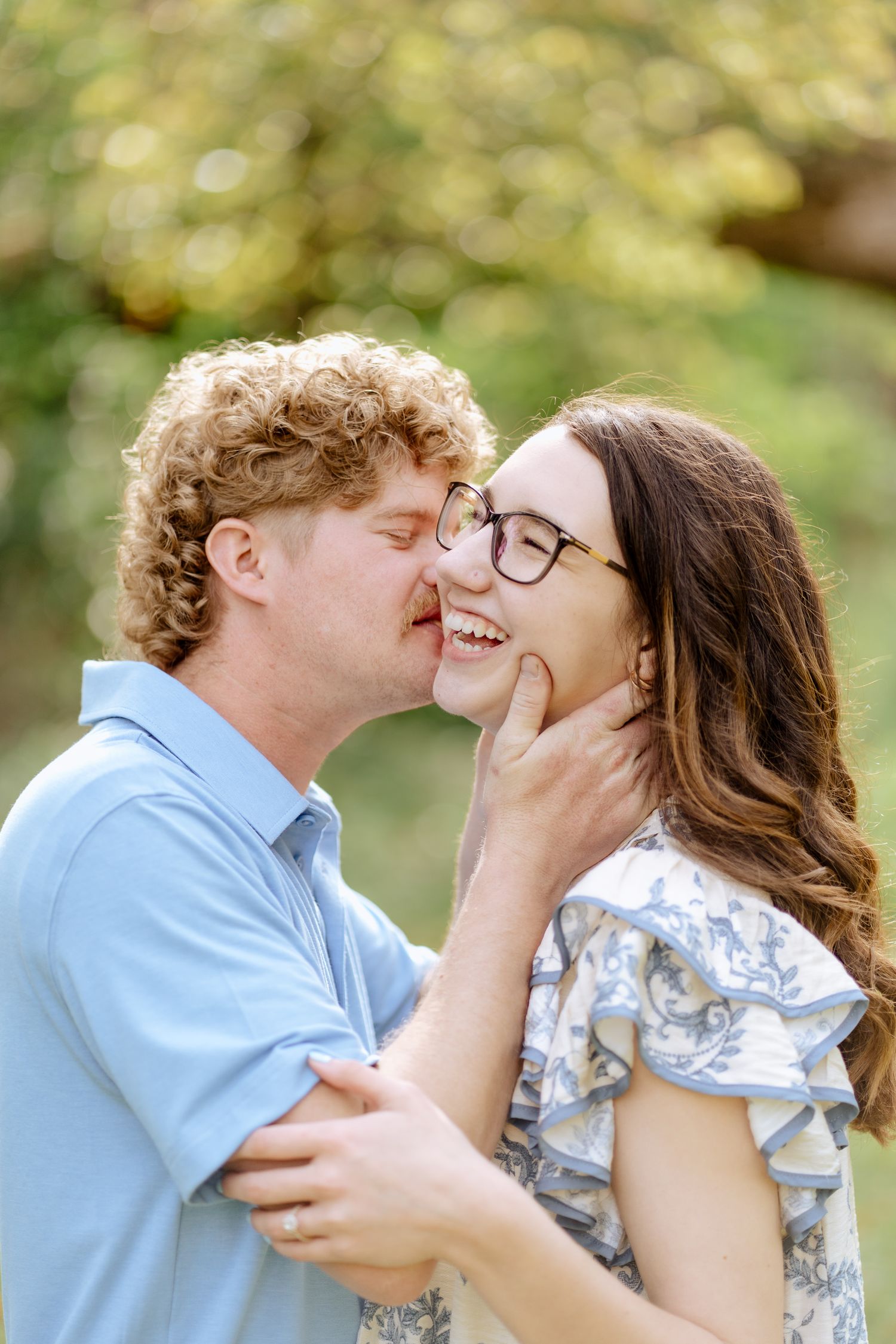 An intimate moment between a couple during an outdoor portrait session.