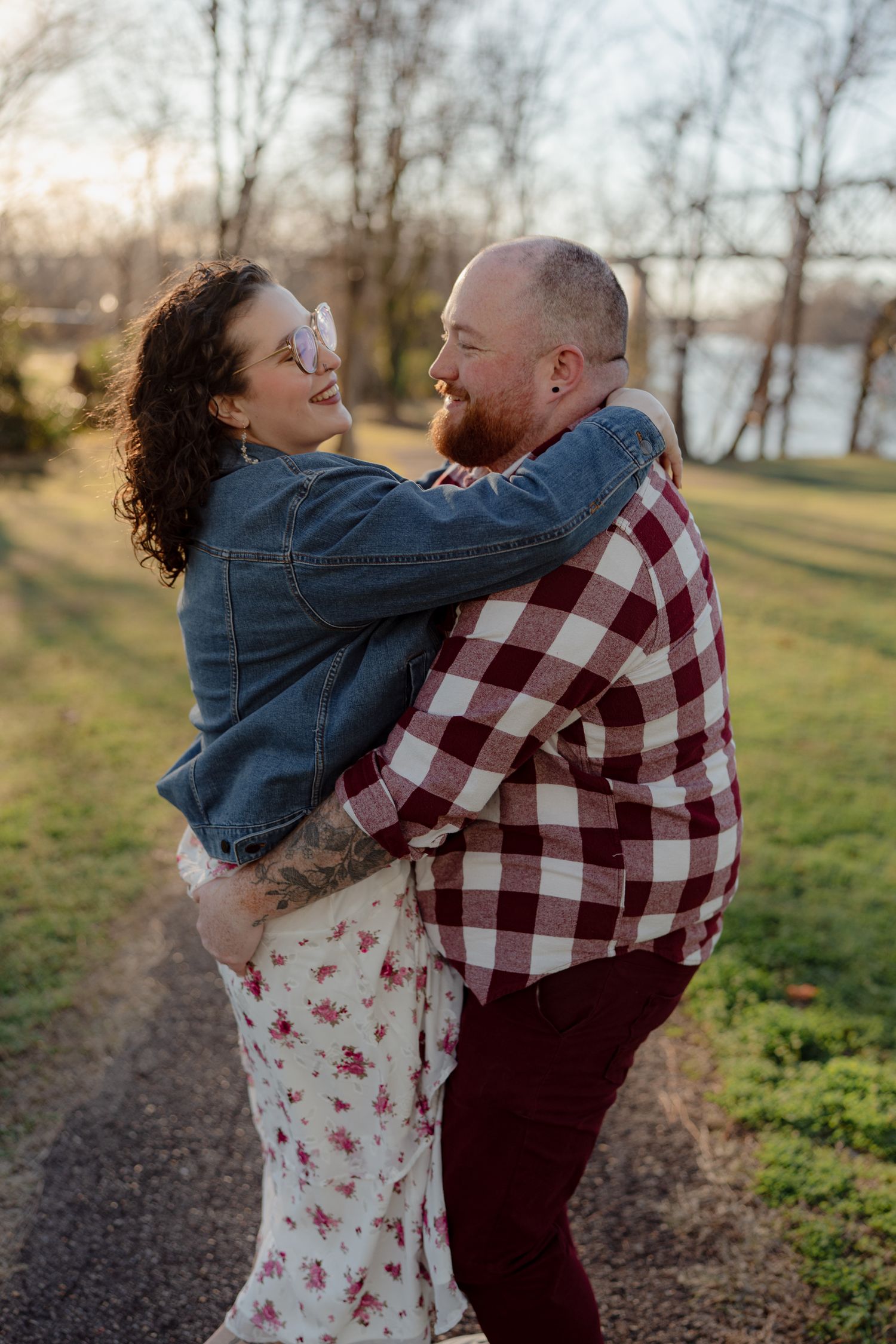 A romantic outdoor photoshoot featuring a couple in coordinating casual outfits.