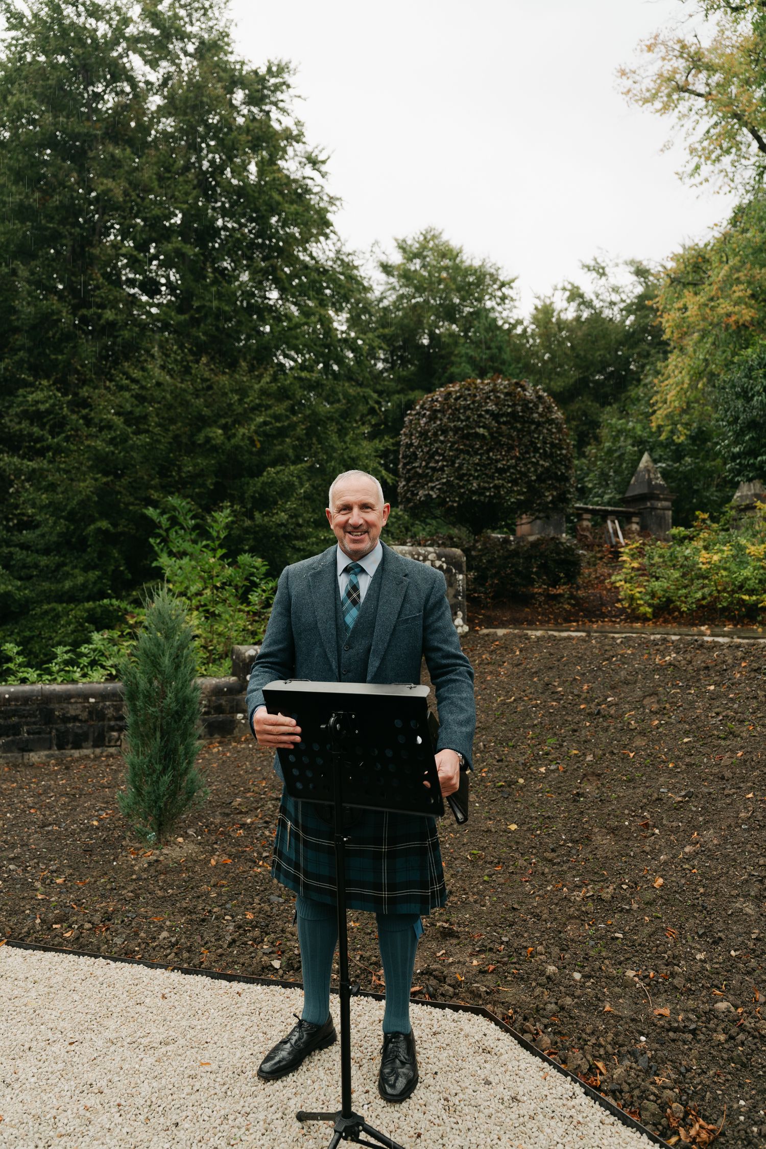 man wearing a kilt smiling at camera
