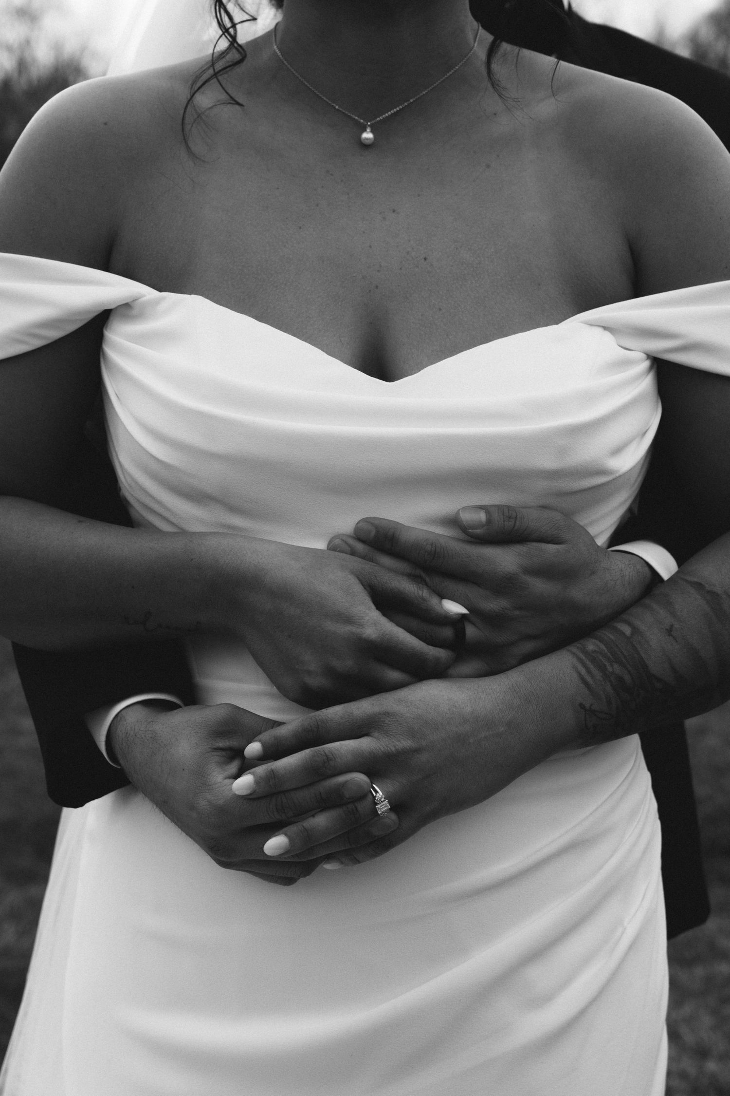 brides dress, grooms hands wrapped around bride