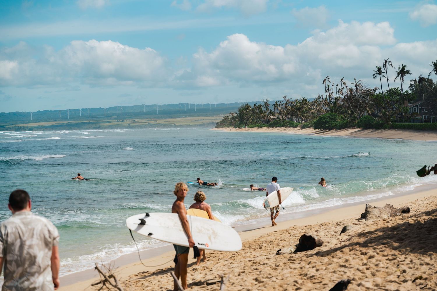 surfers walking to go surf