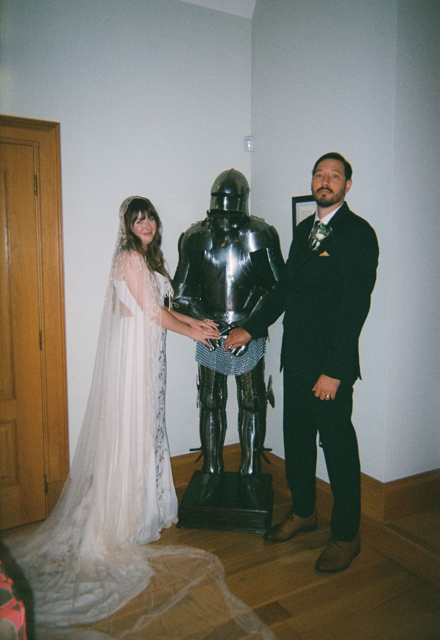 bride and groom holding knights hands