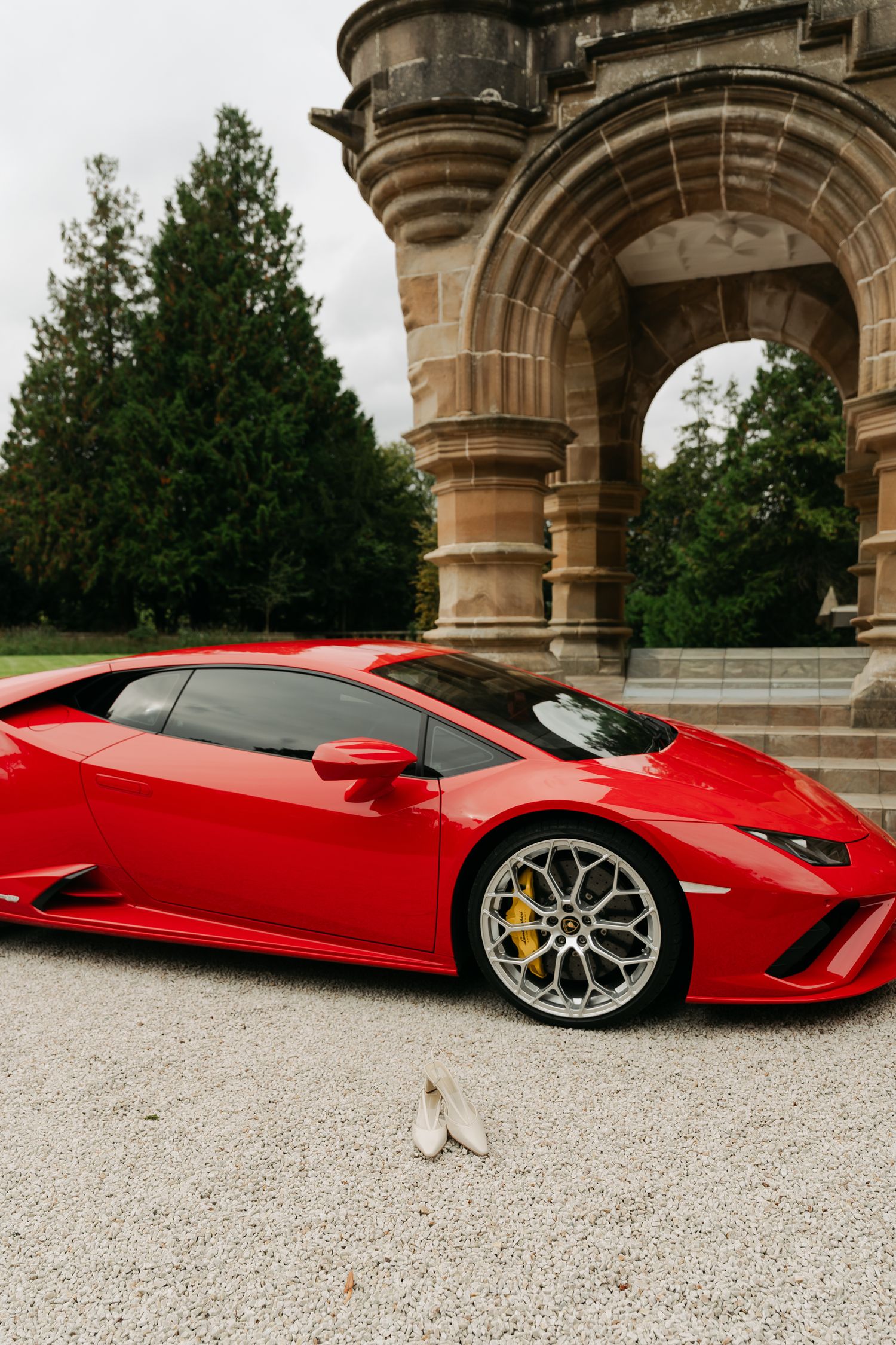 a nice red car, with heels in front of car