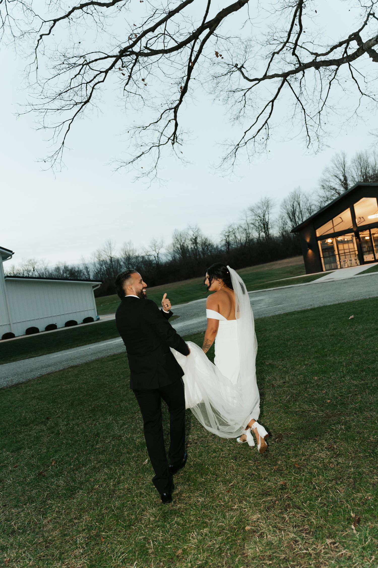 bride and groom walking in a field