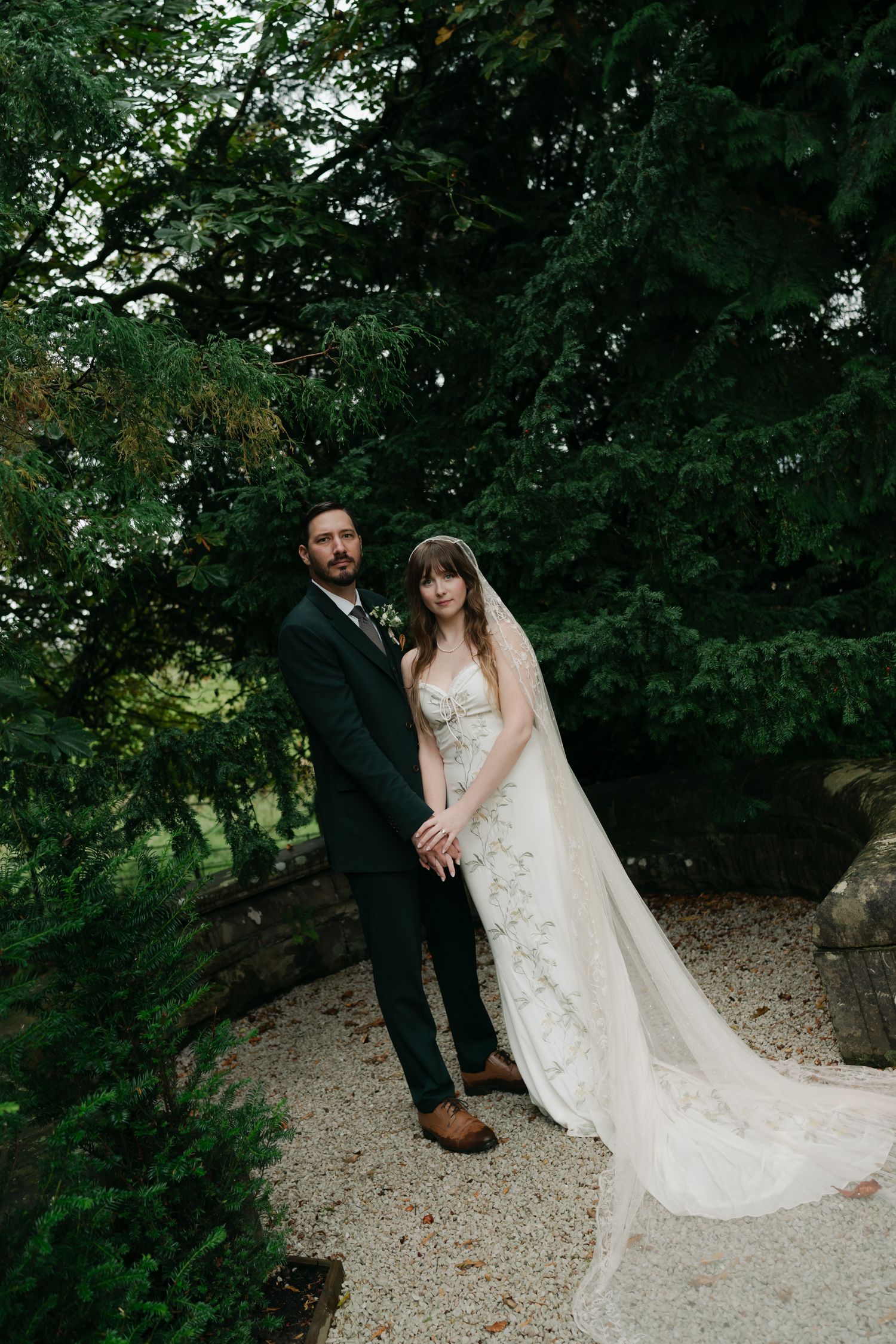 bride and groom standing in a courtyard in Scotland