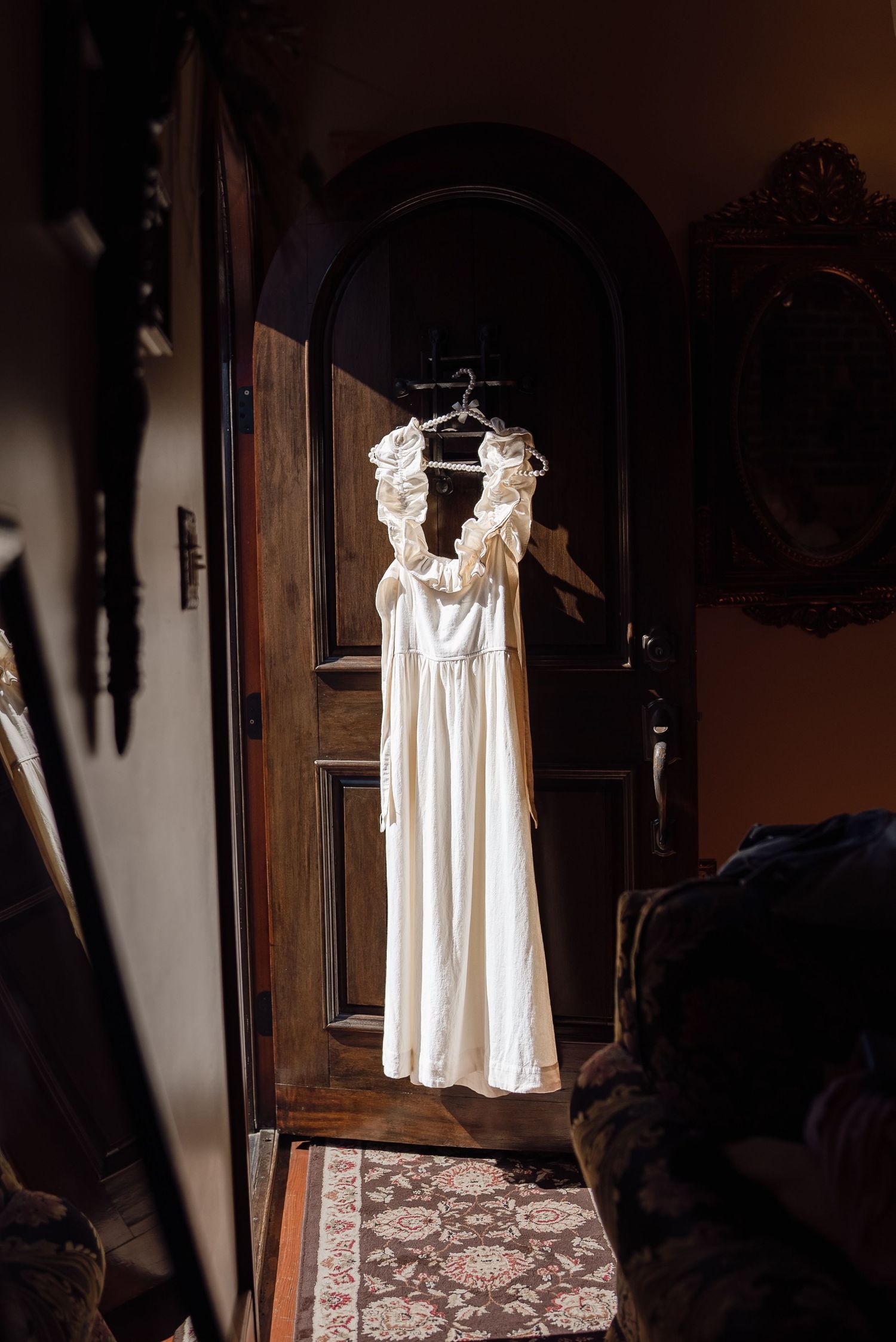 wedding dress hung on door, in Savannah, Georgia