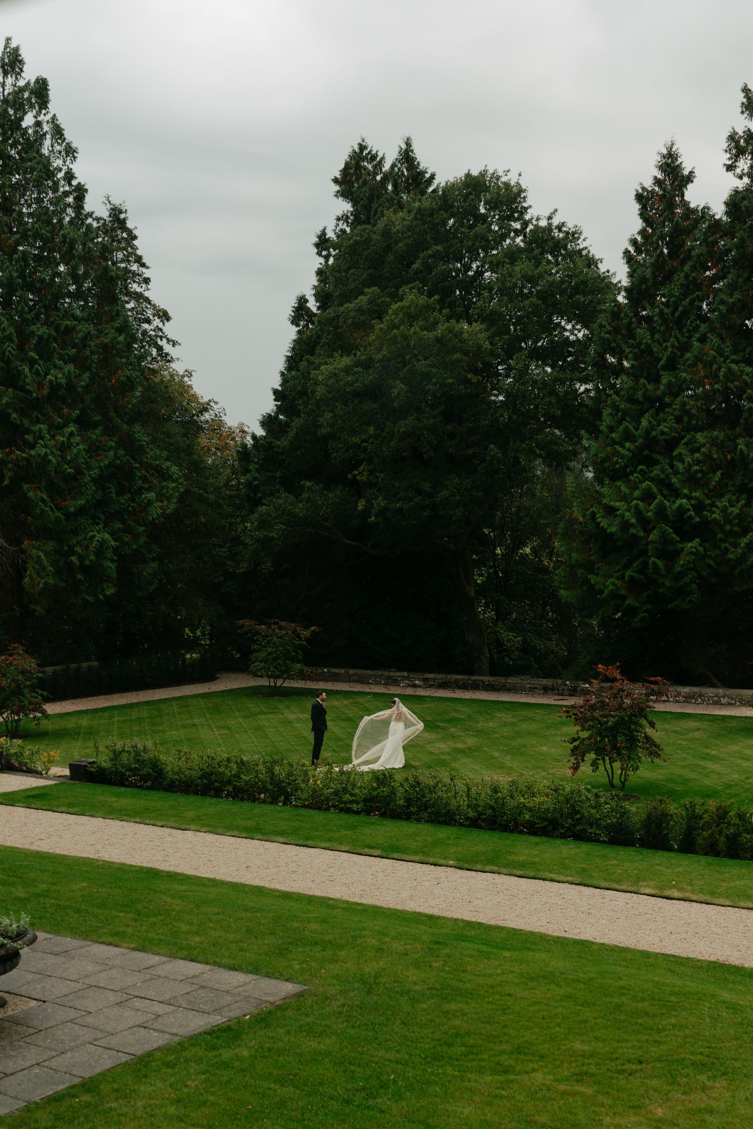 bride and groom standing in a courtyard