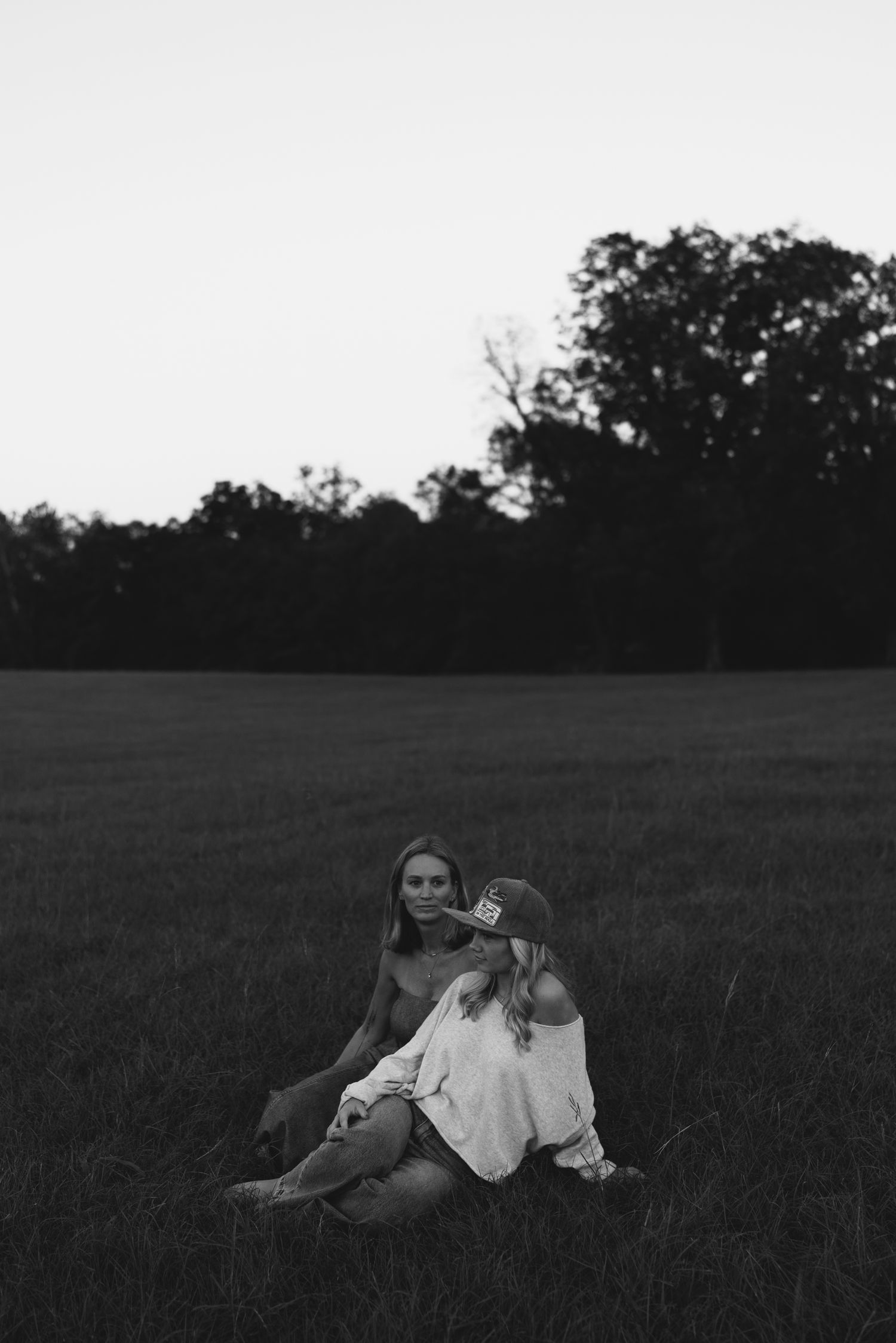 mom and daughter sitting in a field in Georgia