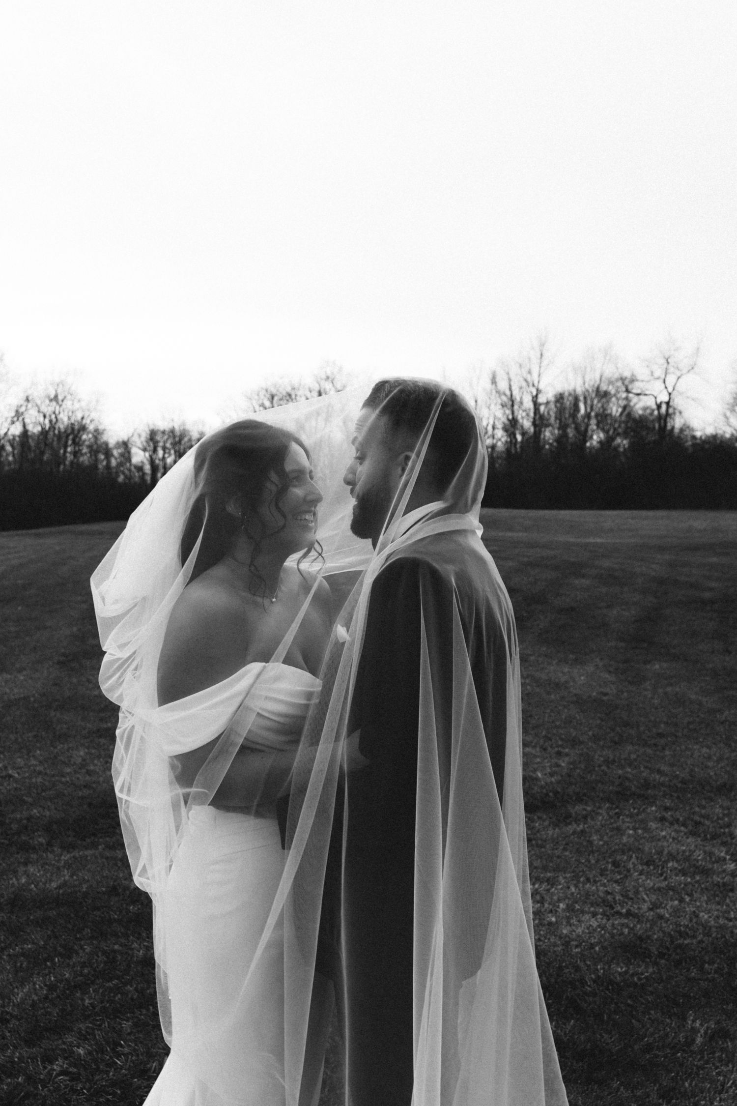 bride and groom under bride's veil