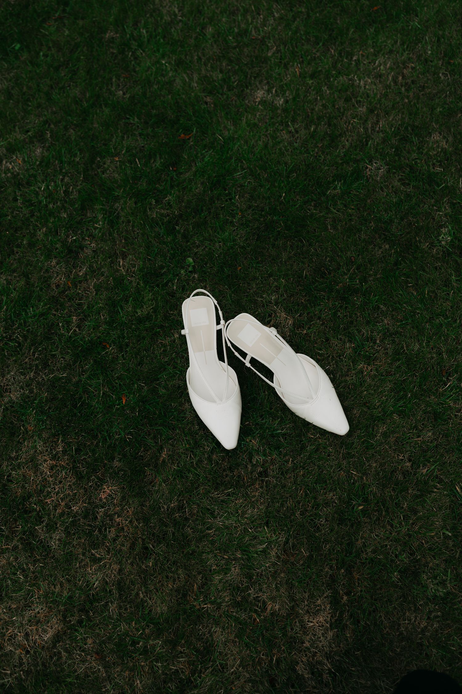 white heels on green grass