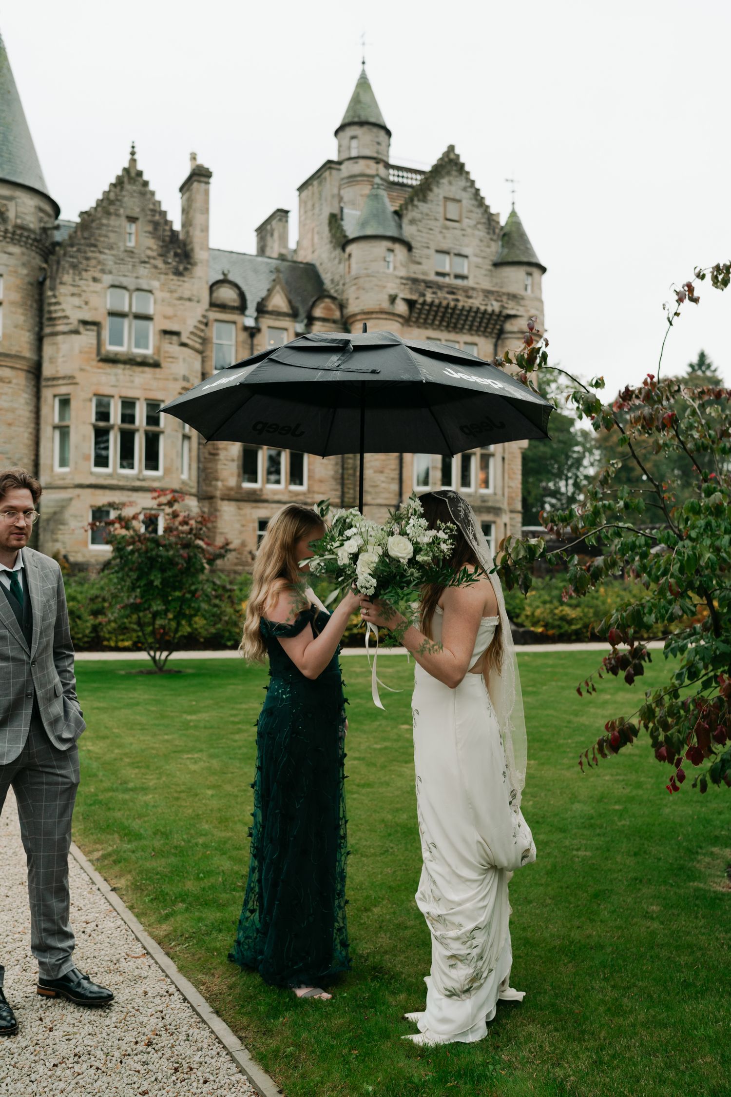 girls standing under an umbrella
