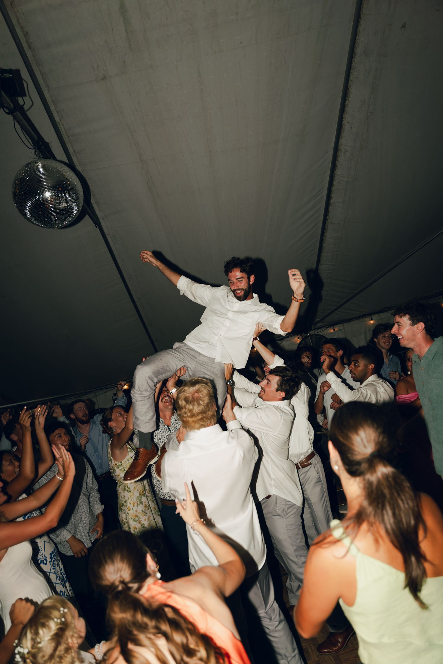 groom being crowdsurfing at reception