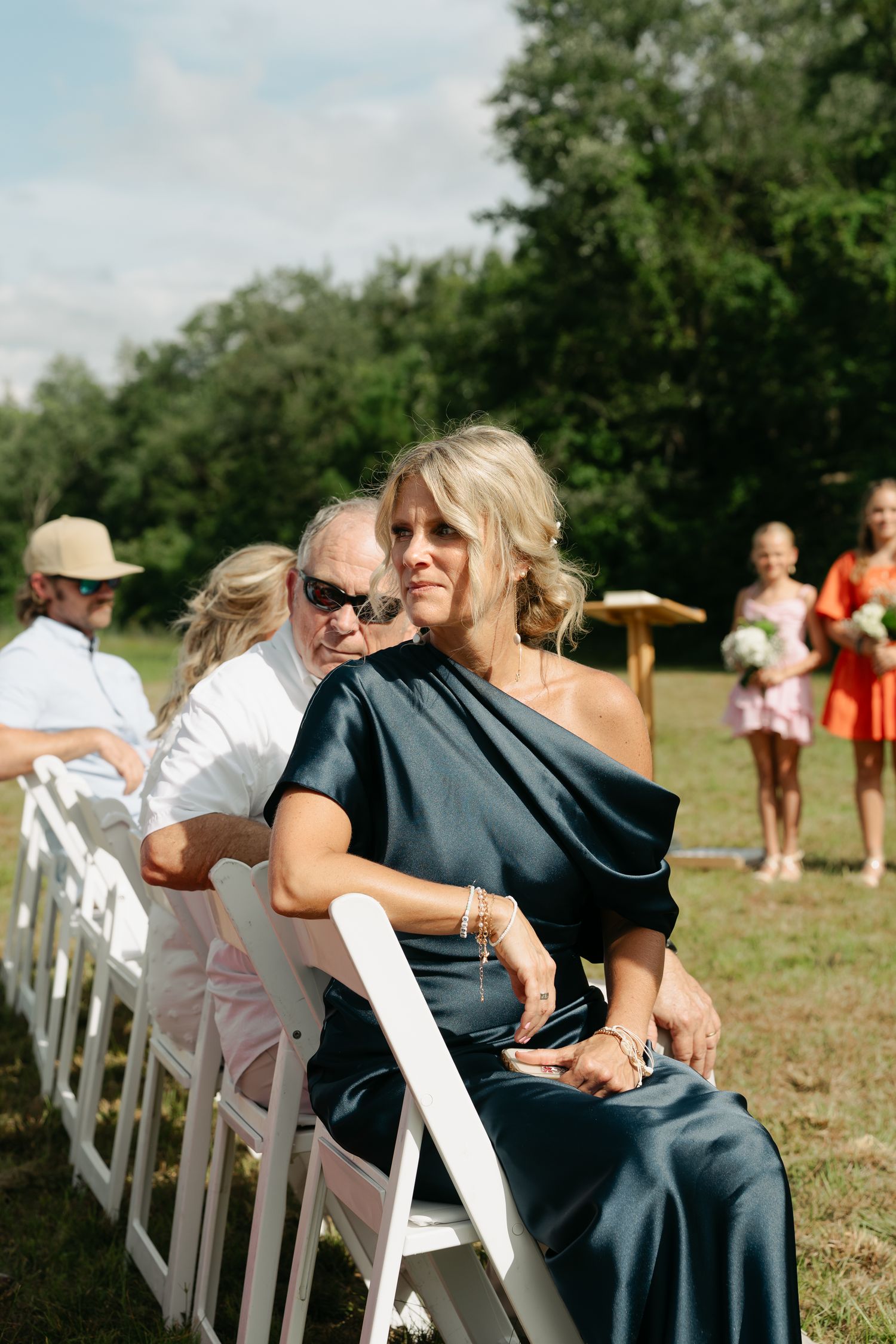 mother of the bride watching her daughter go down the aisle