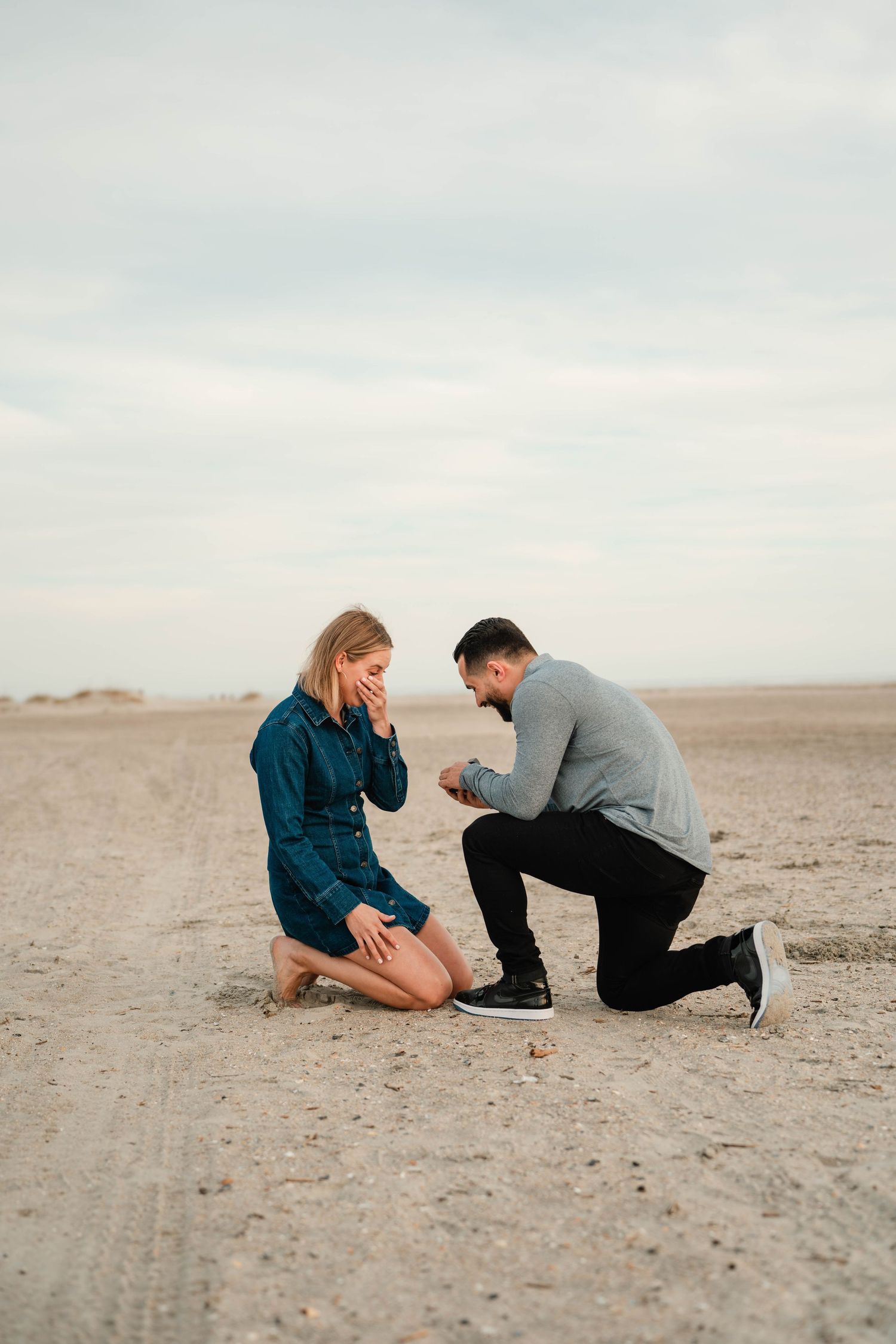man proposing to woman on a beach