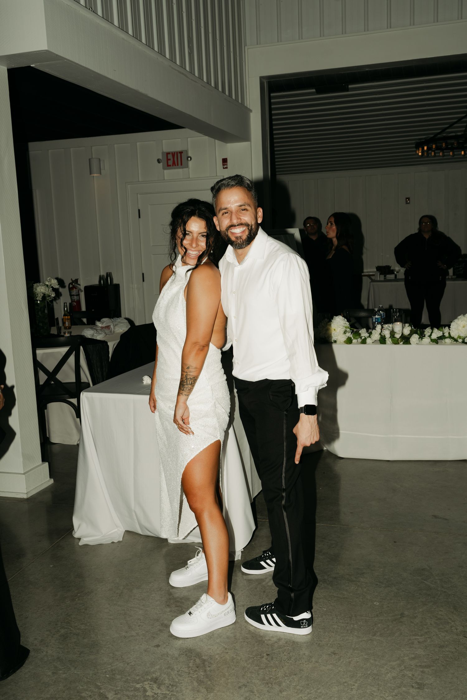 bride and groom pointing at their shoes