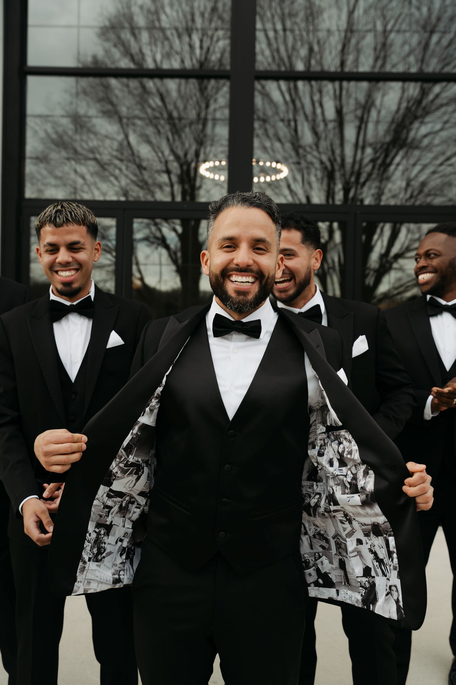groom holding open his tux coat with images on the inside