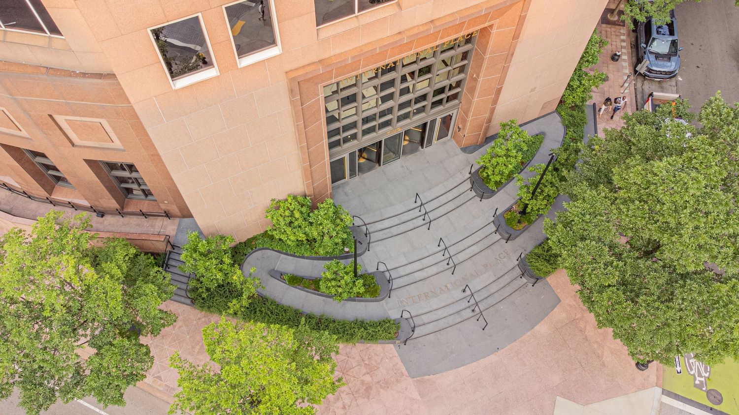 Bird's eye perspective of modern institutional building complex with curved architectural features.