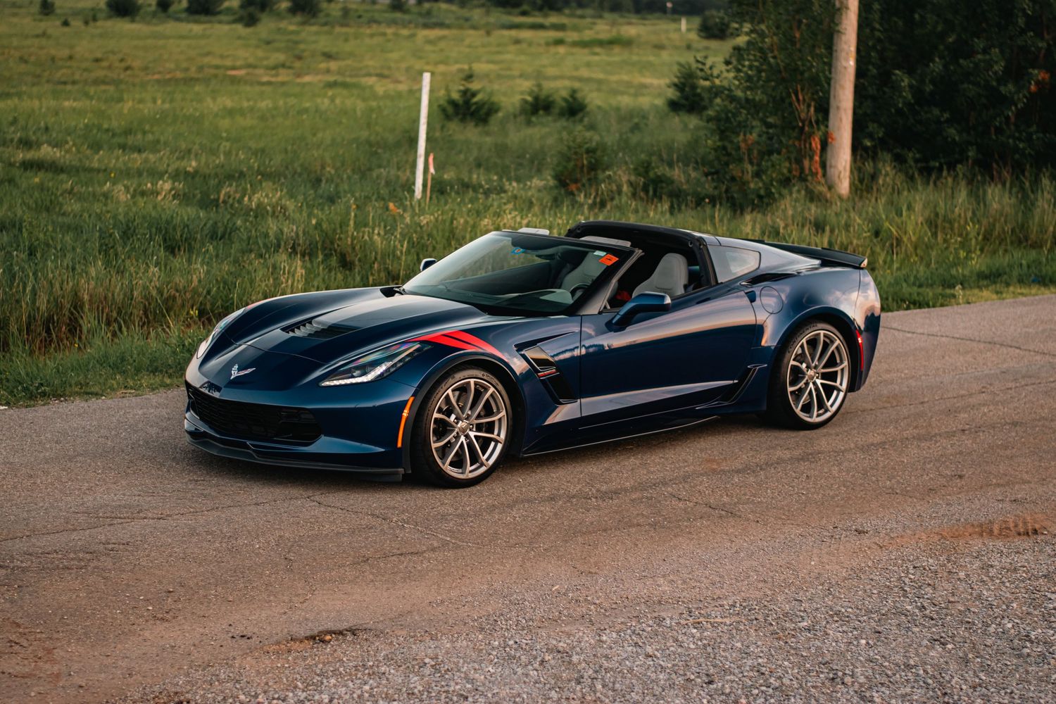 Bold automotive photography of a blue Chevrolet Corvette, showcasing sleek styling, sharp details, and powerful design in natural light.