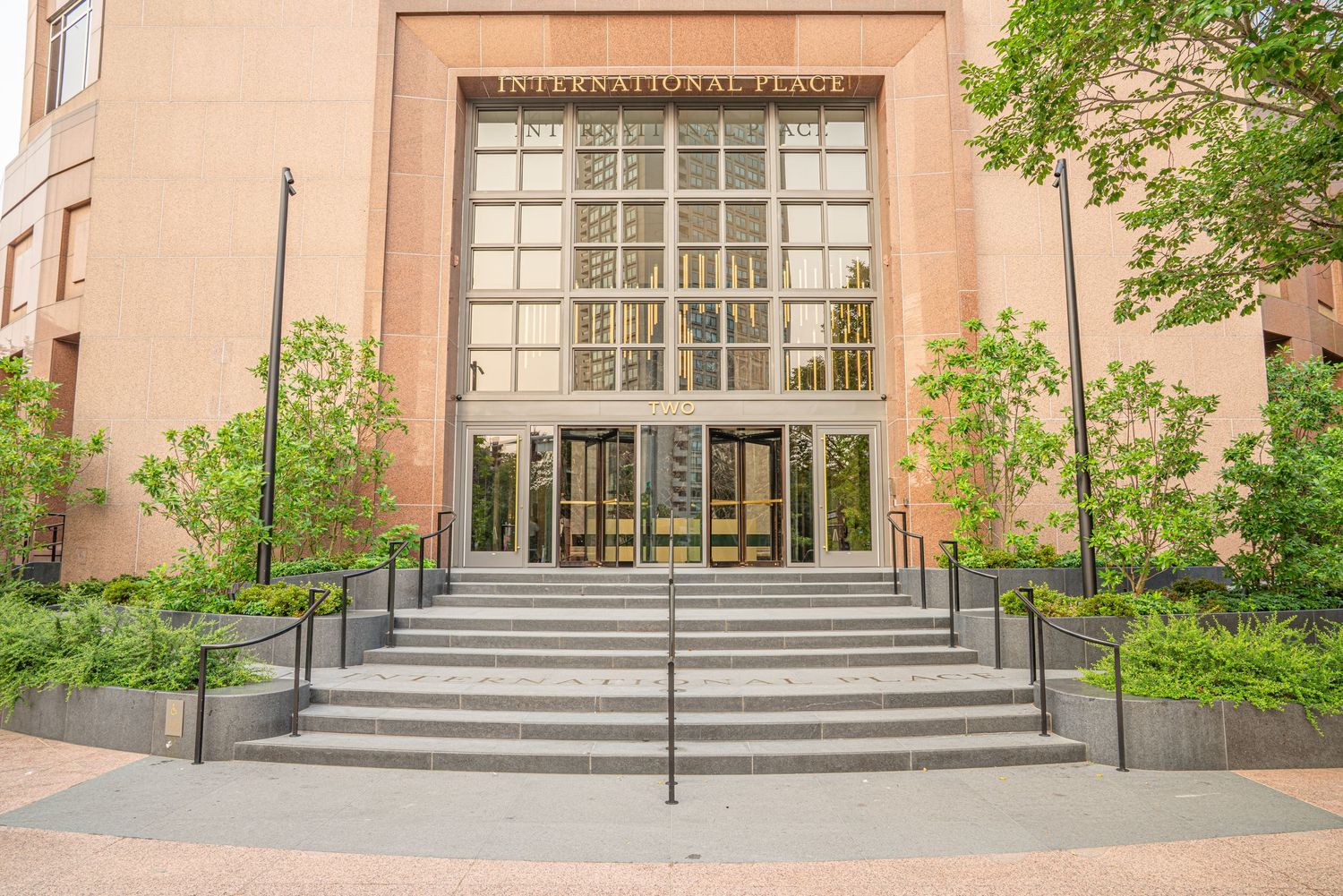 Institutional building entrance with glass block windows and concrete steps with handrails.