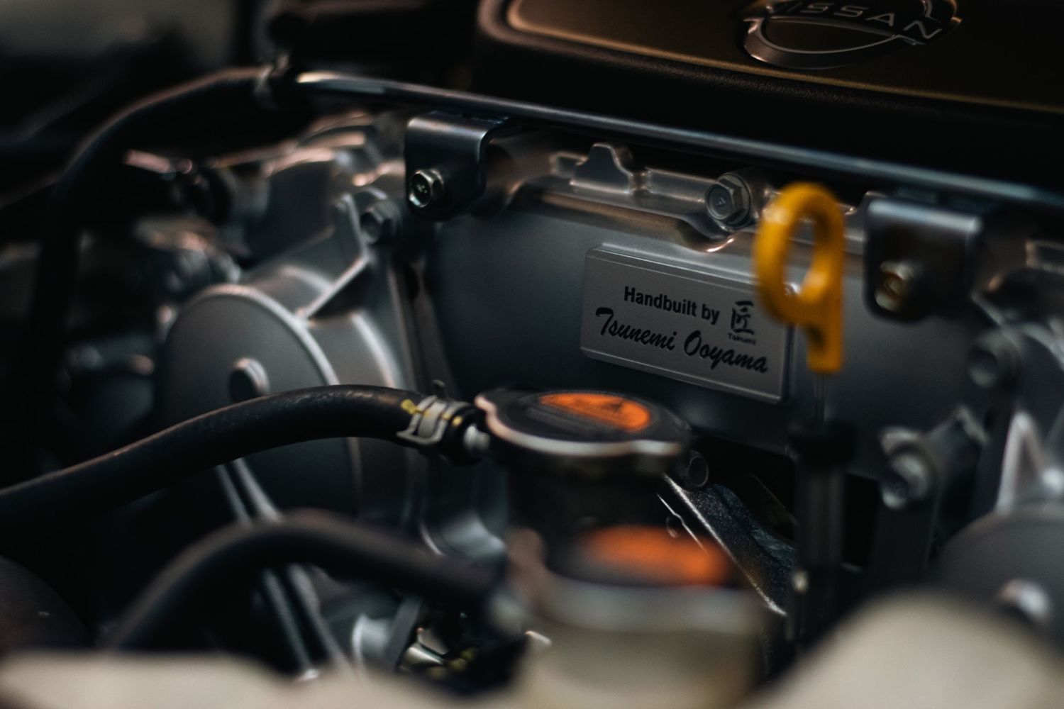 Close-up automotive photography of a detailed engine bay, capturing precision engineering, metallic textures, and mechanical craftsmanship.