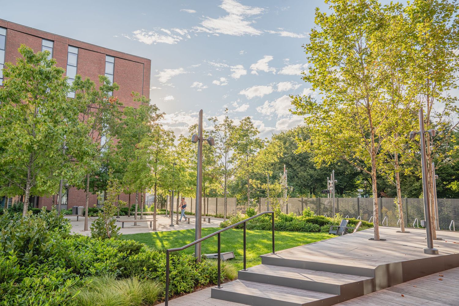 Landscaped campus walkway with modern architectural elements and green spaces.