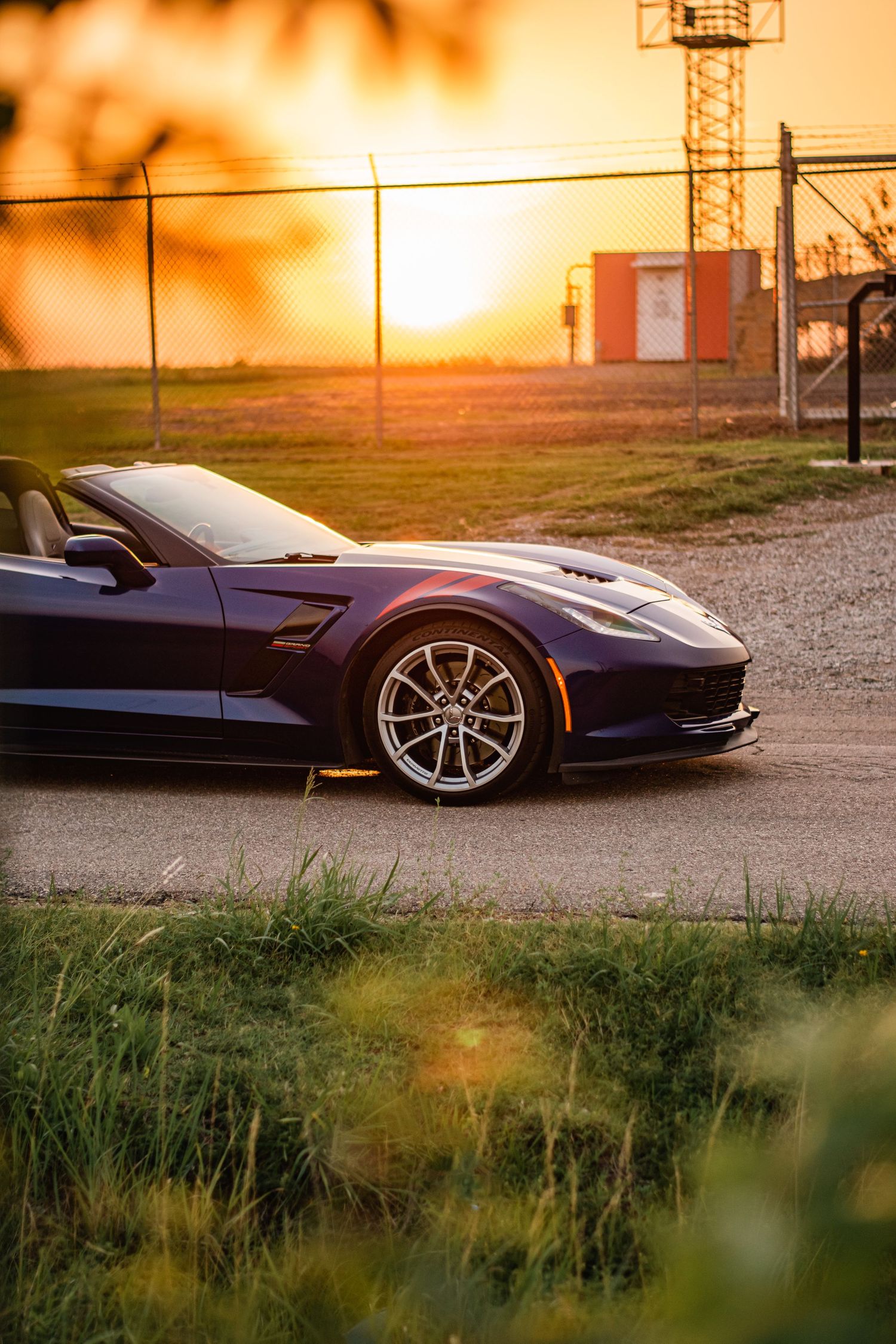 Chevrolet Corvette detail shot at sunset, highlighting sleek curves, polished wheels, and golden hour light for bold automotive photography.