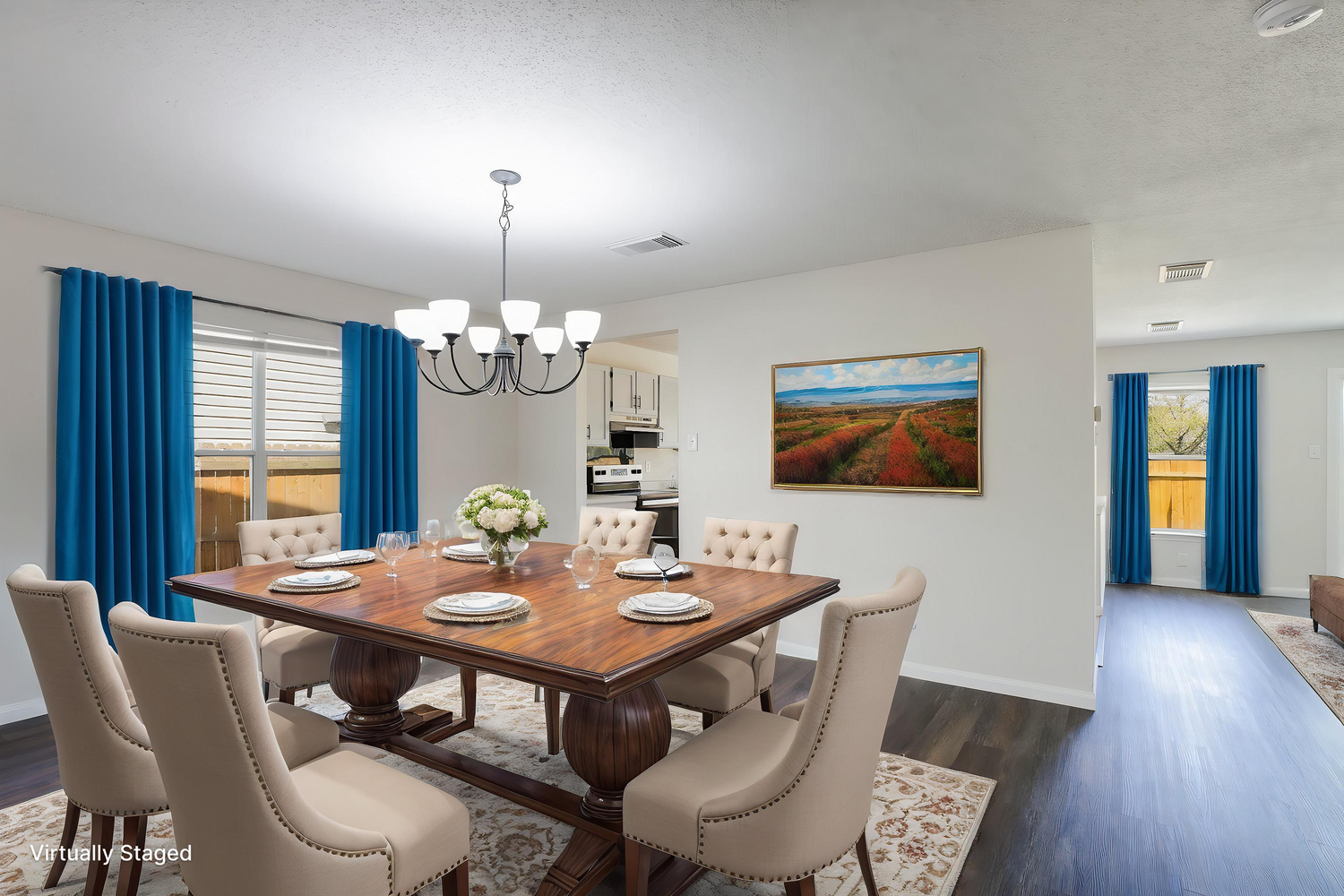 Elegant dining room with wooden table, upholstered chairs, and bright blue curtains.