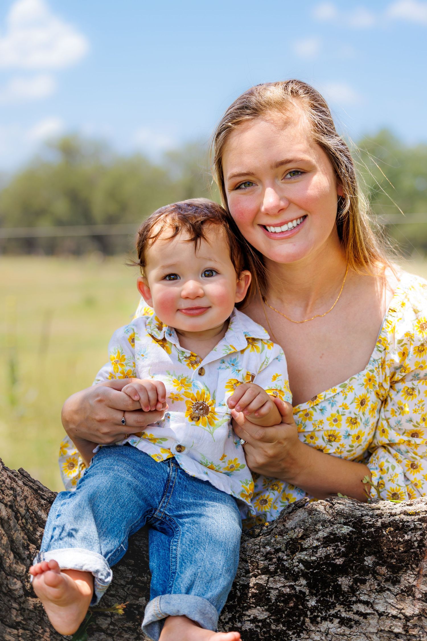 A family photo outdoors with matching floral outfits.